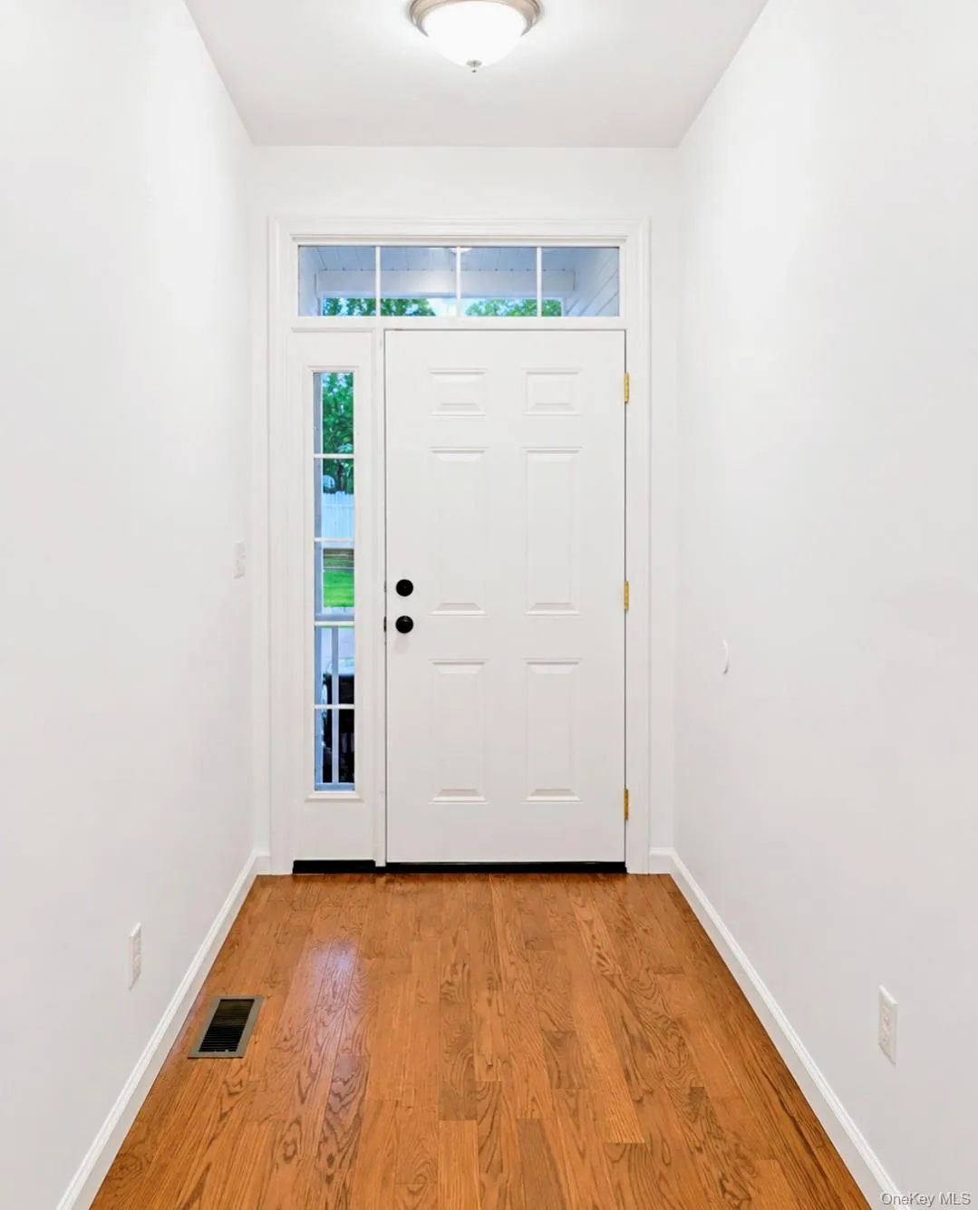 Entryway featuring wood-finish flooring Entryway featuring wood-finish flooring