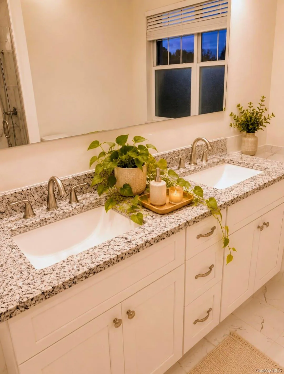 Double vanity with granite countertop, undermount sinks, and brushed nickel fixtures Double vanity with granite countertop, undermount sinks, and brushed nickel fixtures