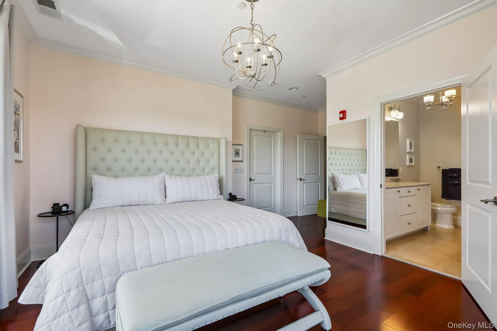 Hardwood flooring, crown molding, a decorative ceiling fixture, and a built-in vanity with a countertop Hardwood flooring, crown molding, a decorative ceiling fixture, and a built-in vanity with a countertop