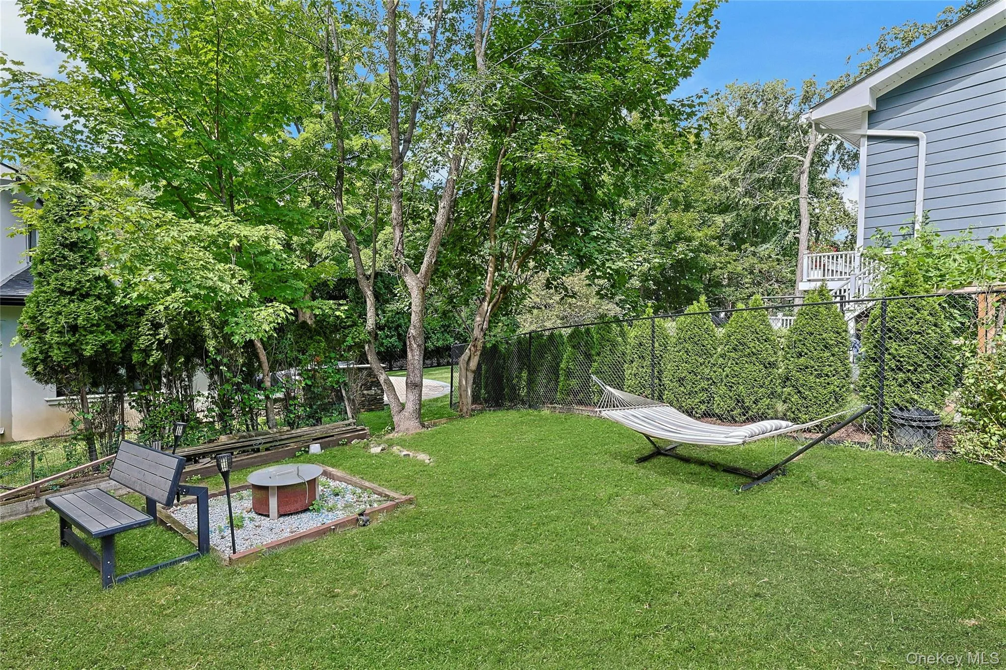 Expansive yard surrounded by trees. Expansive yard surrounded by trees.