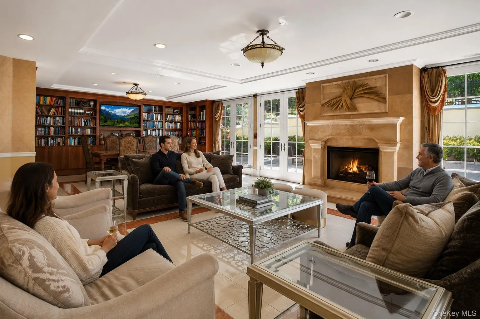 Elegant entry foyer with fireplace for gathering, opens to patio area Elegant entry foyer with fireplace for gathering, opens to patio area