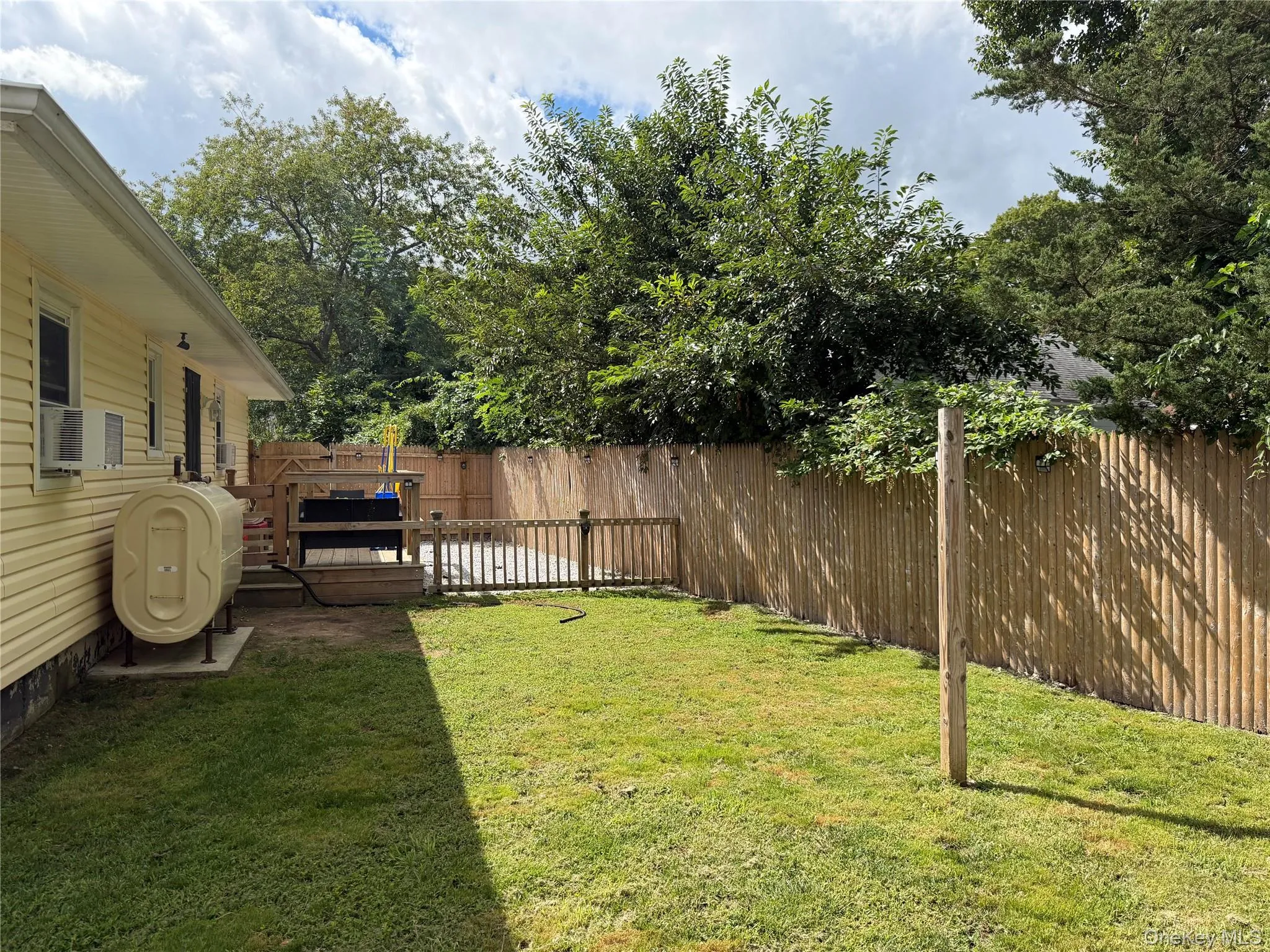 Fully fenced yard with new stockade fencing, dog run area and rear deck. Fully fenced yard with new stockade fencing, dog run area and rear deck.