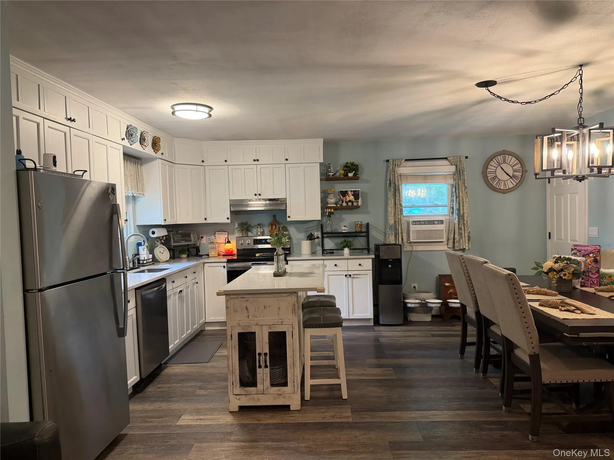 New flooring, center island with quartz countertop, white cabinets. New flooring, center island with quartz countertop, white cabinets.