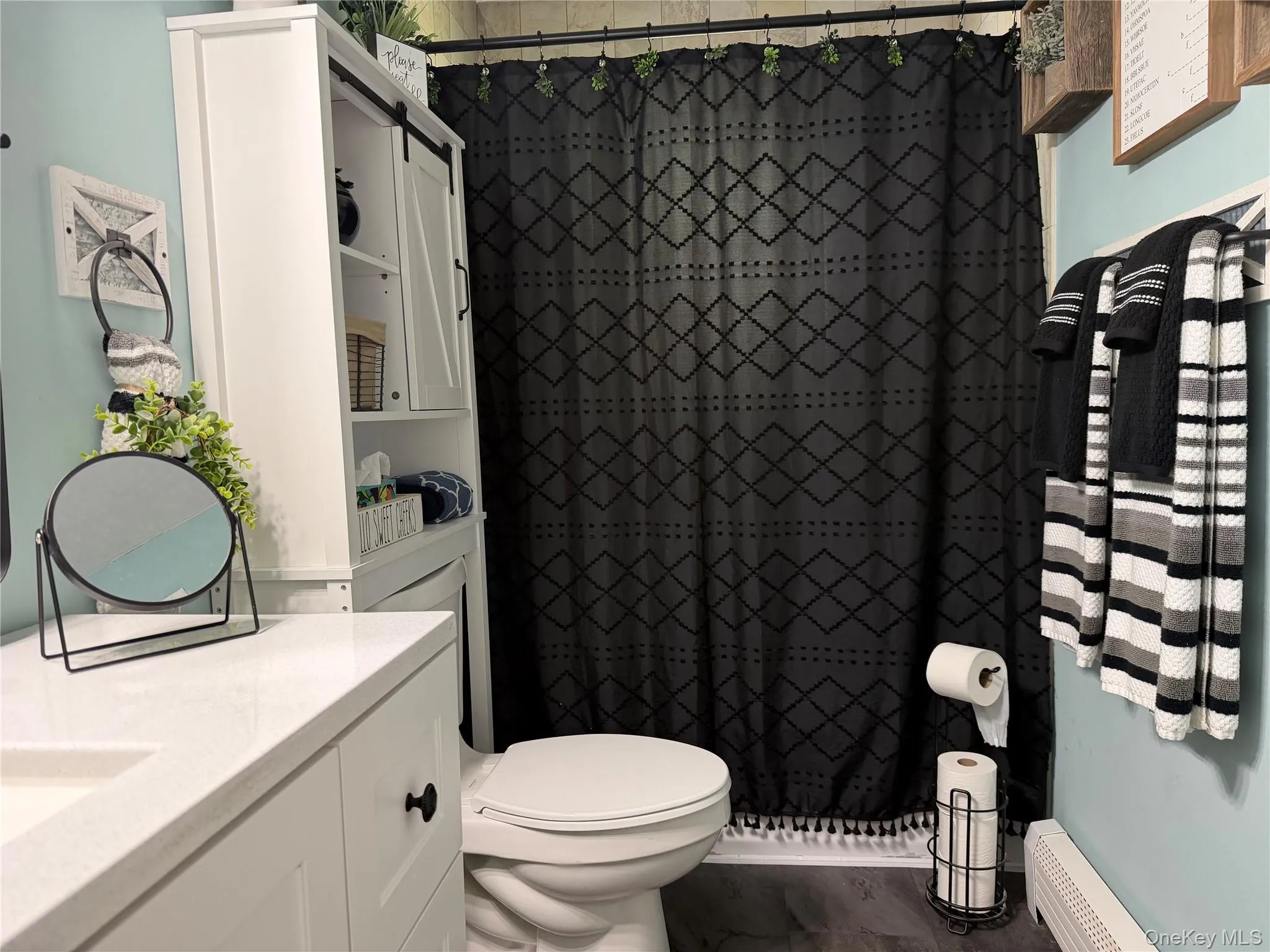 Renovated bath with quartz countertop and full tub with shower. Renovated bath with quartz countertop and full tub with shower.