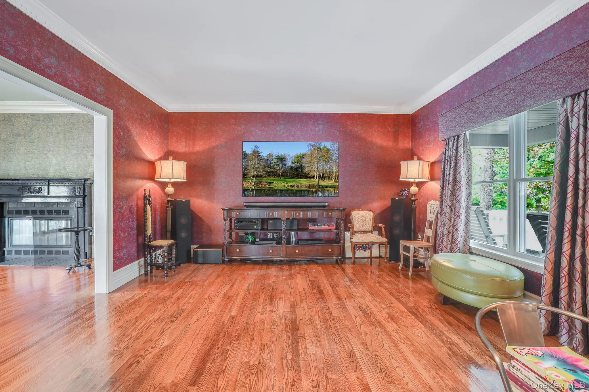 Hardwood flooring, crown molding, bay window, and ornate fireplace surround. Hardwood flooring, crown molding, bay window, and ornate fireplace surround.