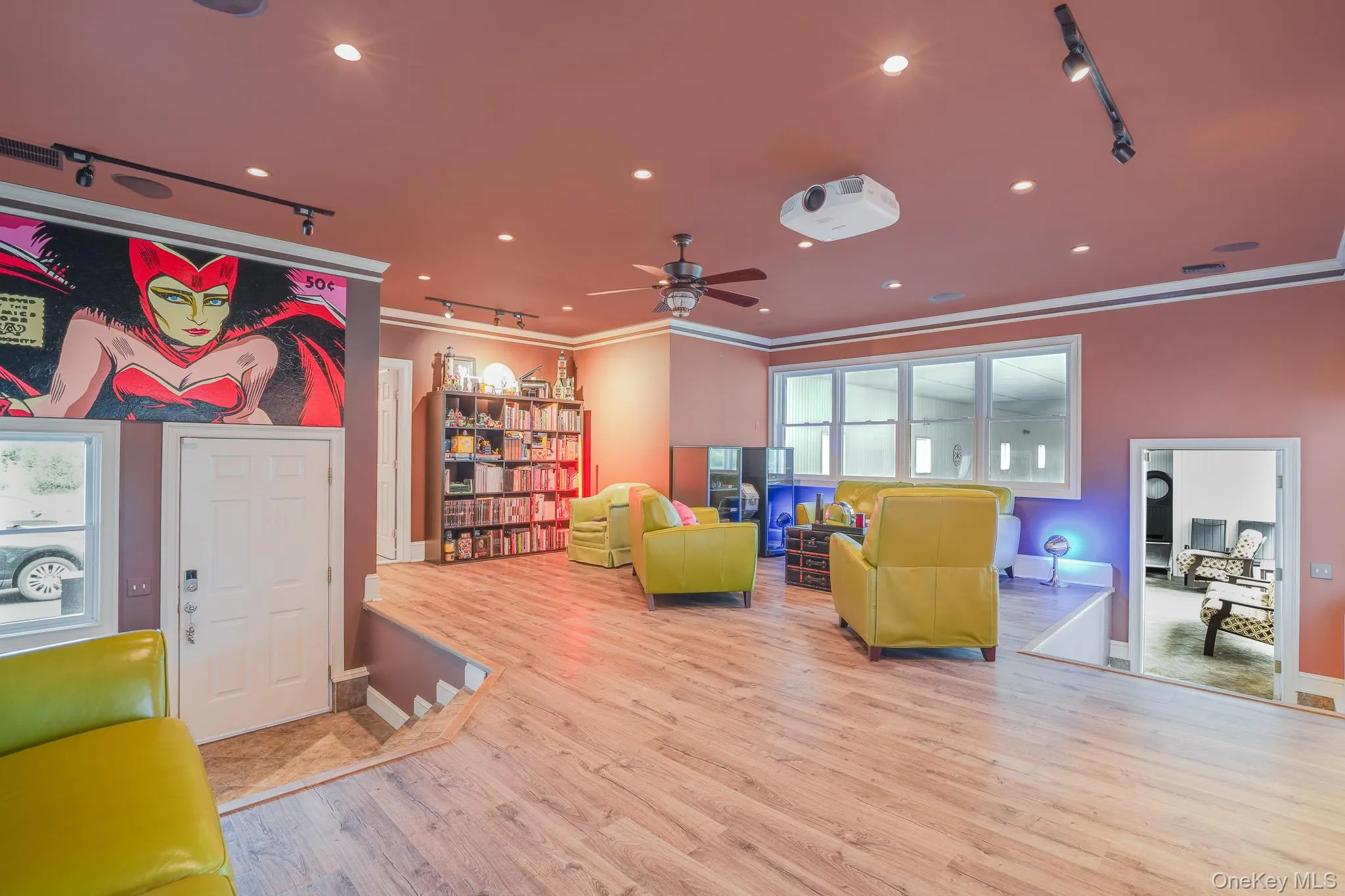 Den with cozy lighting, wood finish flooring, recessed lighting leading to a full bathroom and indoor pool. Den with cozy lighting, wood finish flooring, recessed lighting leading to a full bathroom and indoor pool.