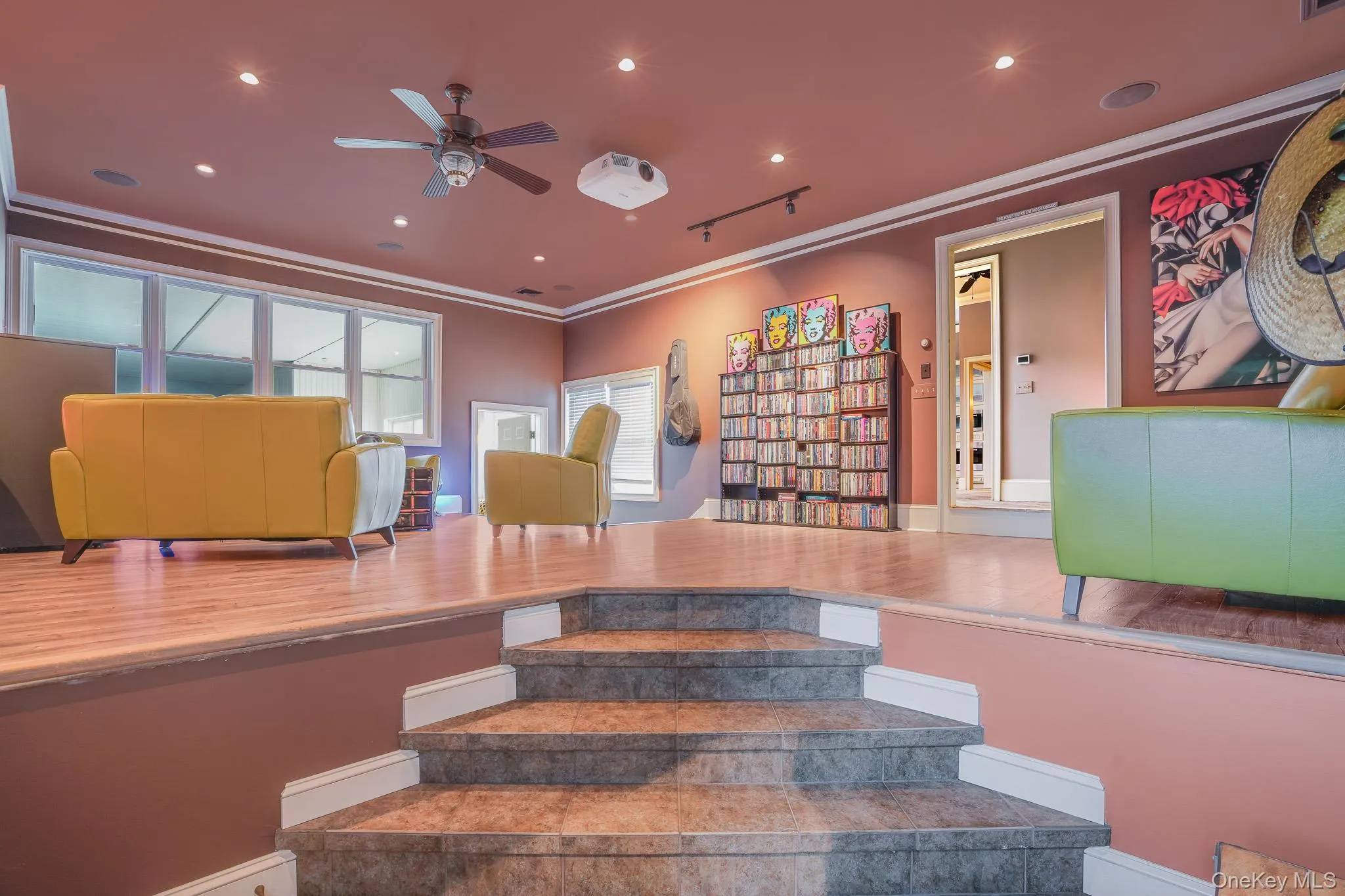 Den with cozy lighting, wood finish flooring, recessed lighting leading to a full bathroom and indoor pool. Den with cozy lighting, wood finish flooring, recessed lighting leading to a full bathroom and indoor pool.