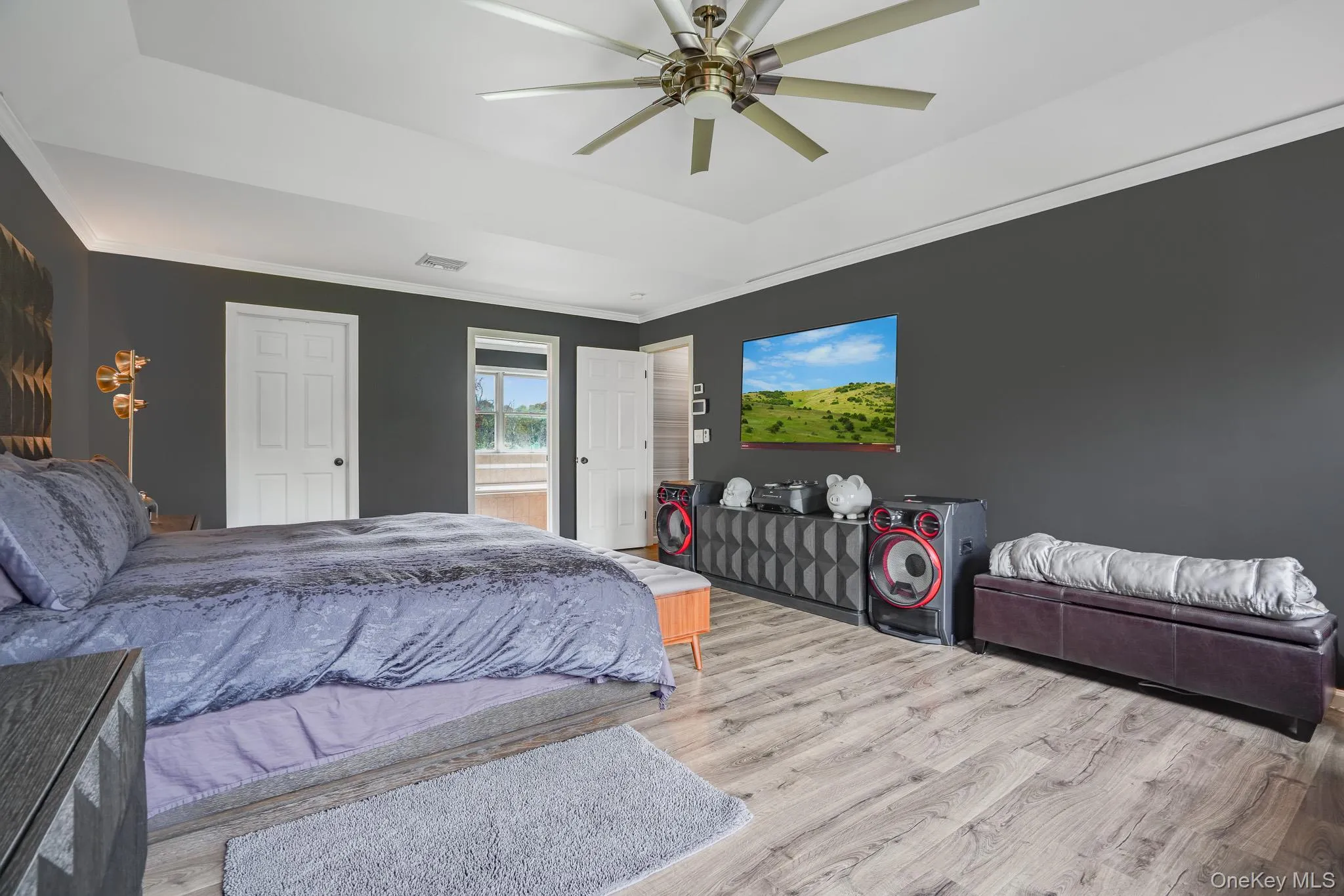 Tray ceiling with a ceiling fan, wood-finish flooring, and white trim Tray ceiling with a ceiling fan, wood-finish flooring, and white trim