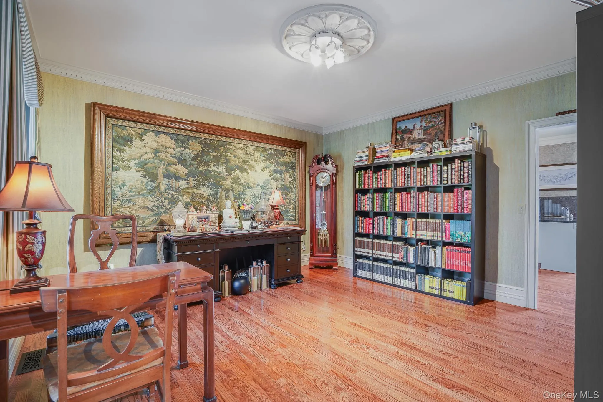 Hardwood flooring, crown molding, a built-in ceiling medallion, a large built-in bookshelf. Hardwood flooring, crown molding, a built-in ceiling medallion, a large built-in bookshelf.