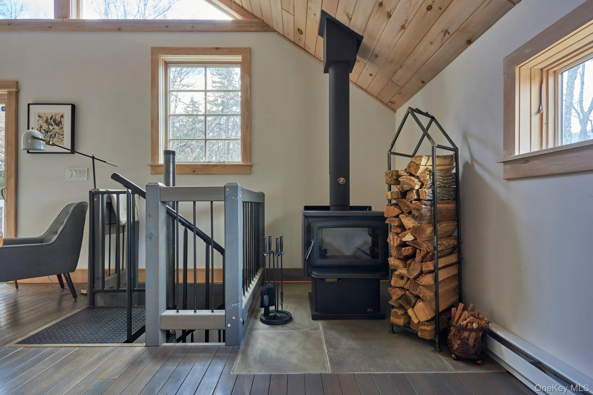 Stairway featuring a wood stove and vaulted ceiling. Stairway featuring a wood stove and vaulted ceiling.