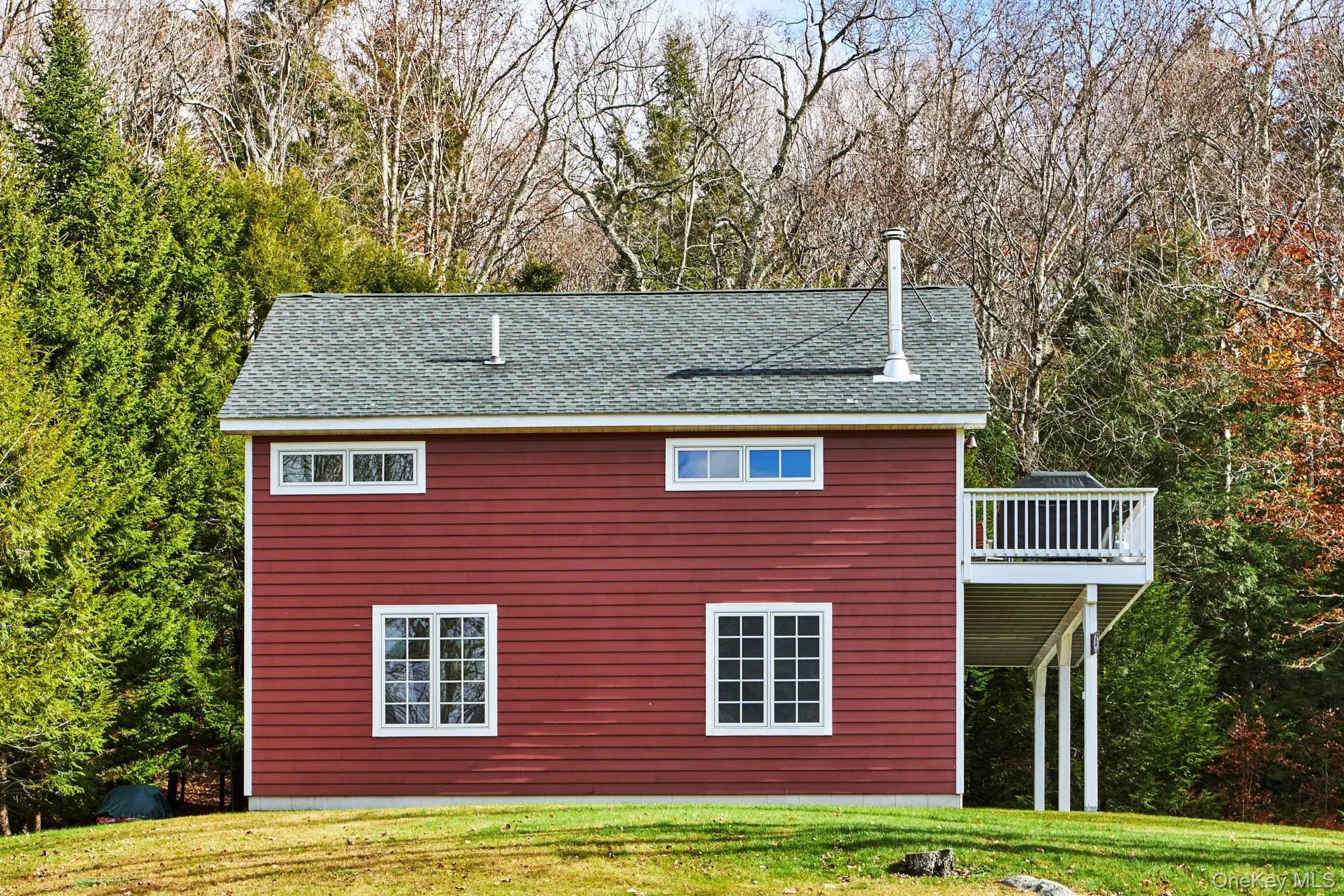 View of side of property featuring a large deck. View of side of property featuring a large deck.