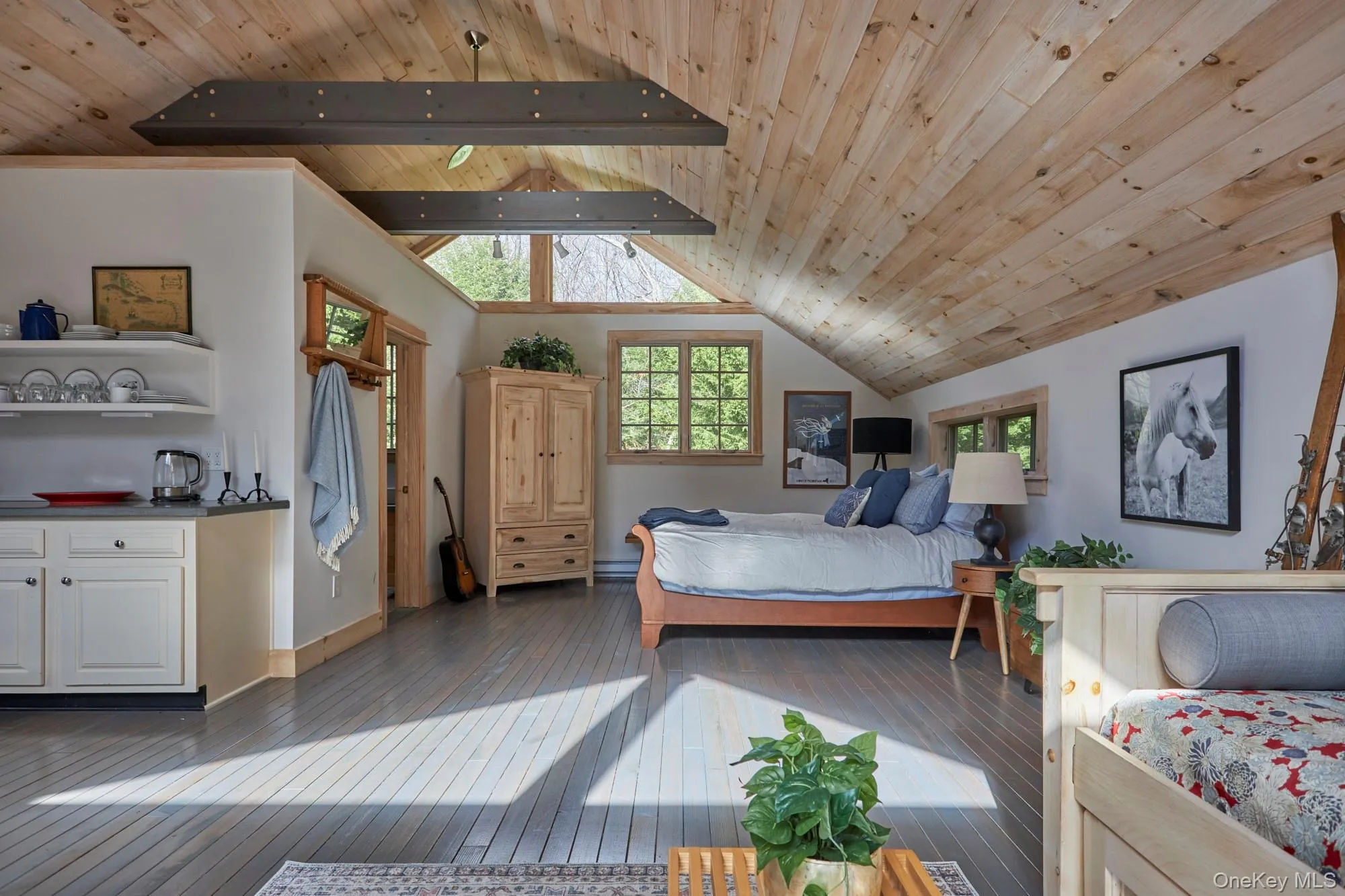 Bedroom featuring a wood ceiling with exposed beams, and high vaulted ceiling Bedroom featuring a wood ceiling with exposed beams, and high vaulted ceiling