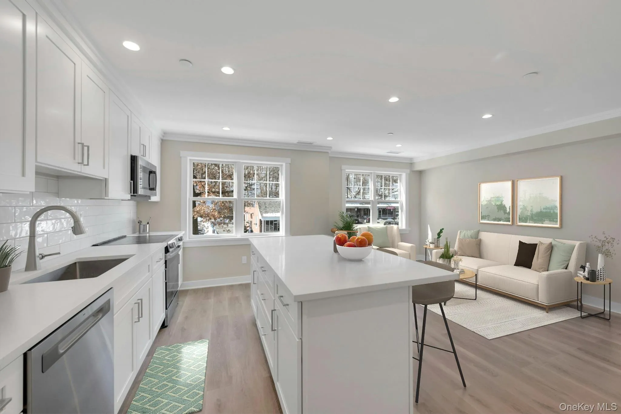 Kitchen with white cabinets, a kitchen island, open floor plan, stainless steel appliances, and a sink Kitchen with white cabinets, a kitchen island, open floor plan, stainless steel appliances, and a sink