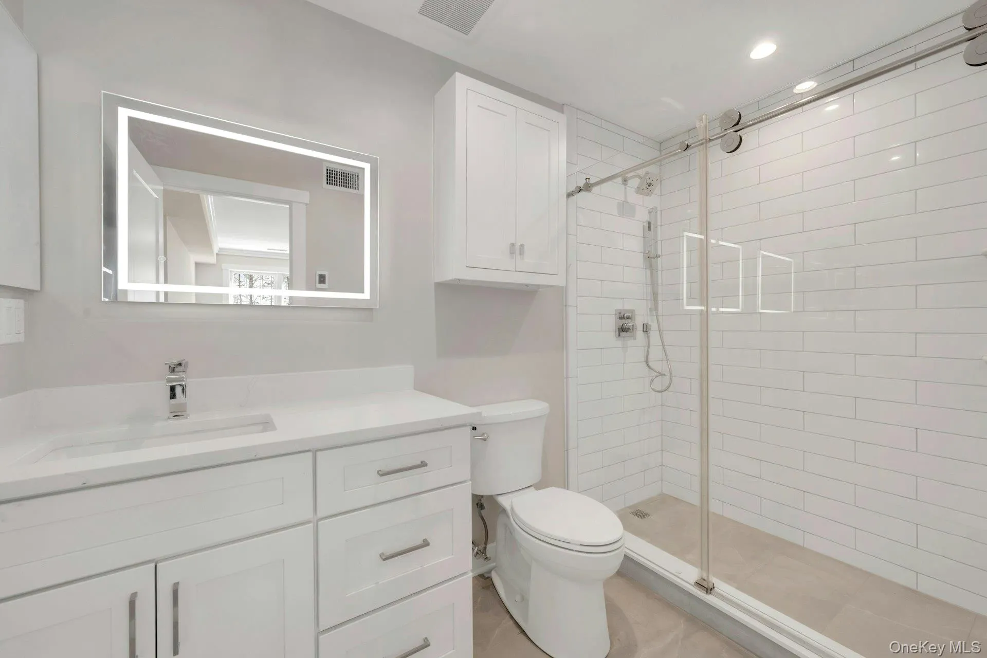Full bath featuring toilet, vanity and a shower stall Full bath featuring toilet, vanity and a shower stall