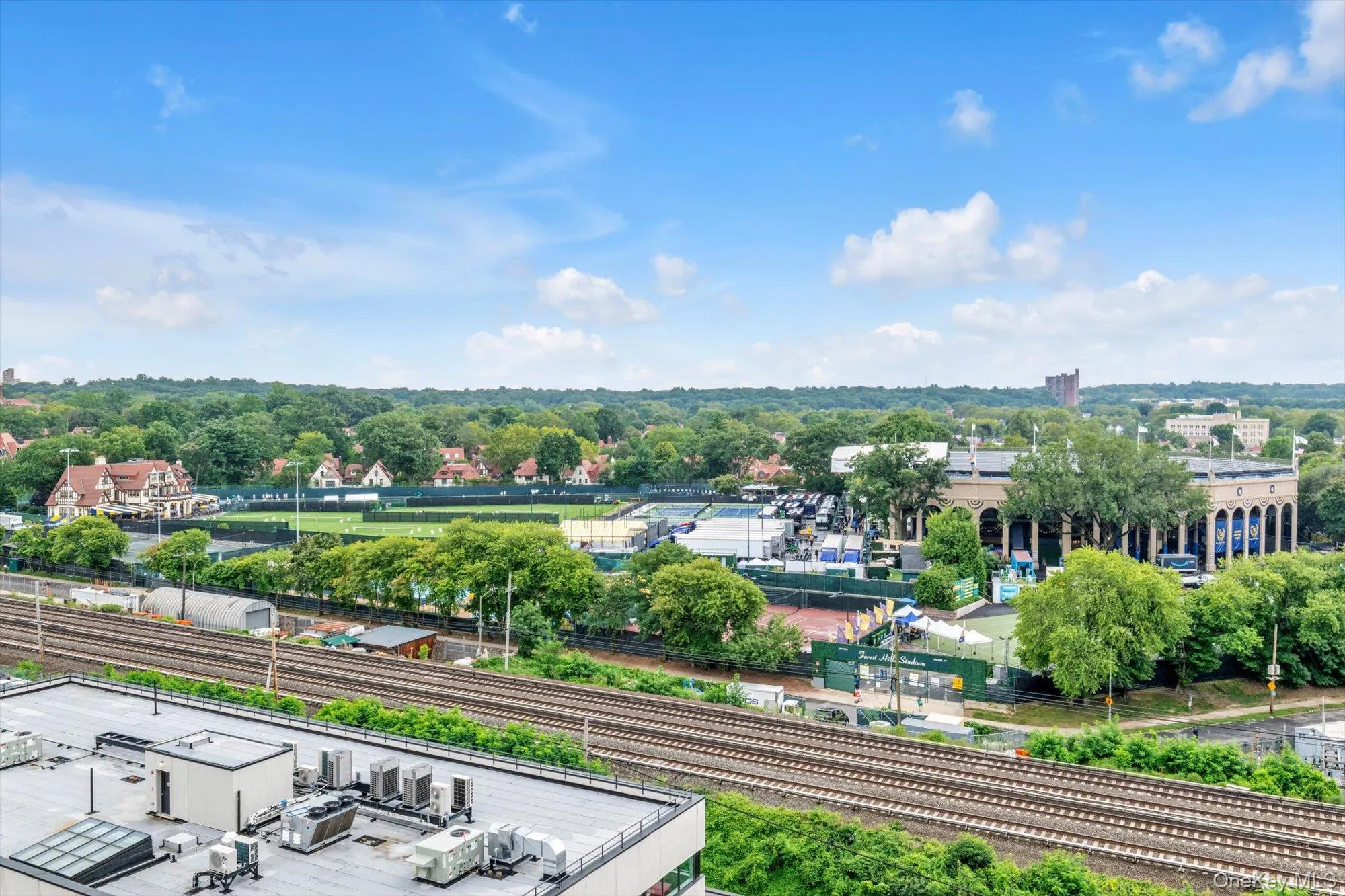 Expansive urban landscape with extensive greenery and residential structures Expansive urban landscape with extensive greenery and residential structures