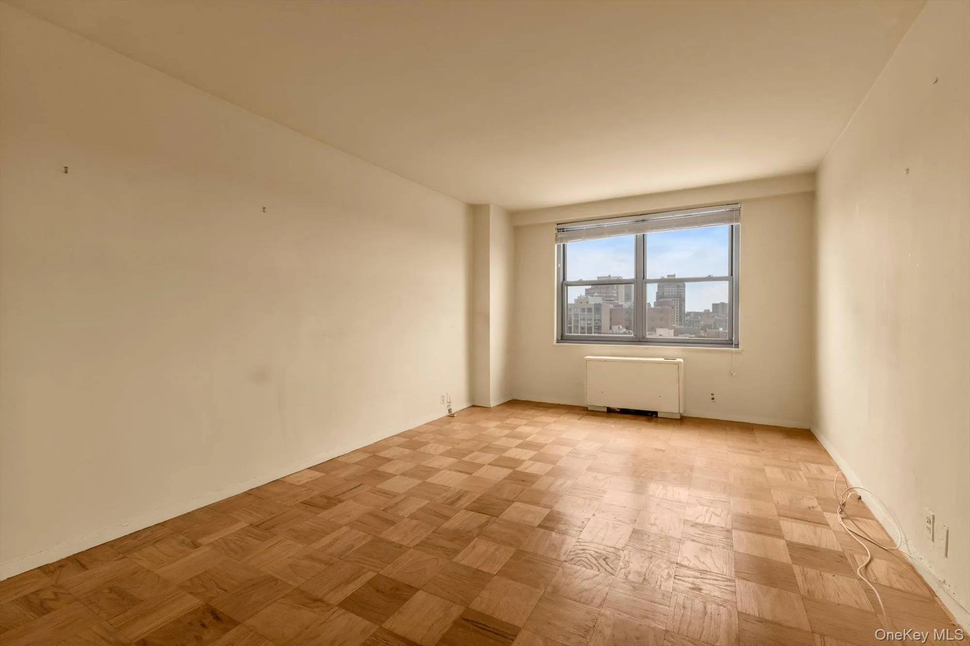 Parquet wood flooring, large window, forced air unit, light-colored walls, high ceilings Parquet wood flooring, large window, forced air unit, light-colored walls, high ceilings
