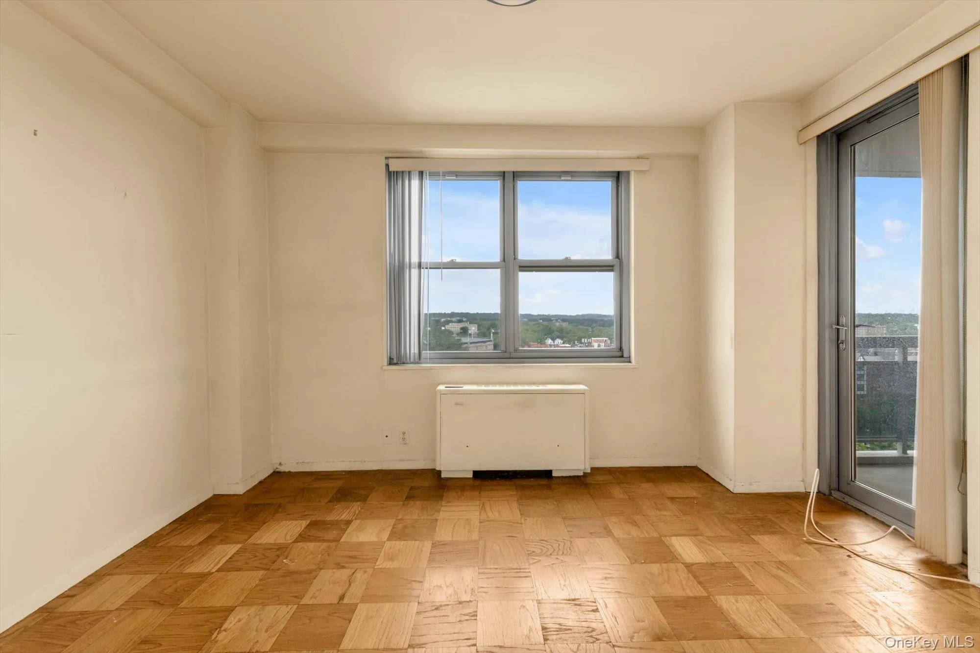 Parquet wood-finish flooring, large window with natural light, and a glass-paneled door Parquet wood-finish flooring, large window with natural light, and a glass-paneled door
