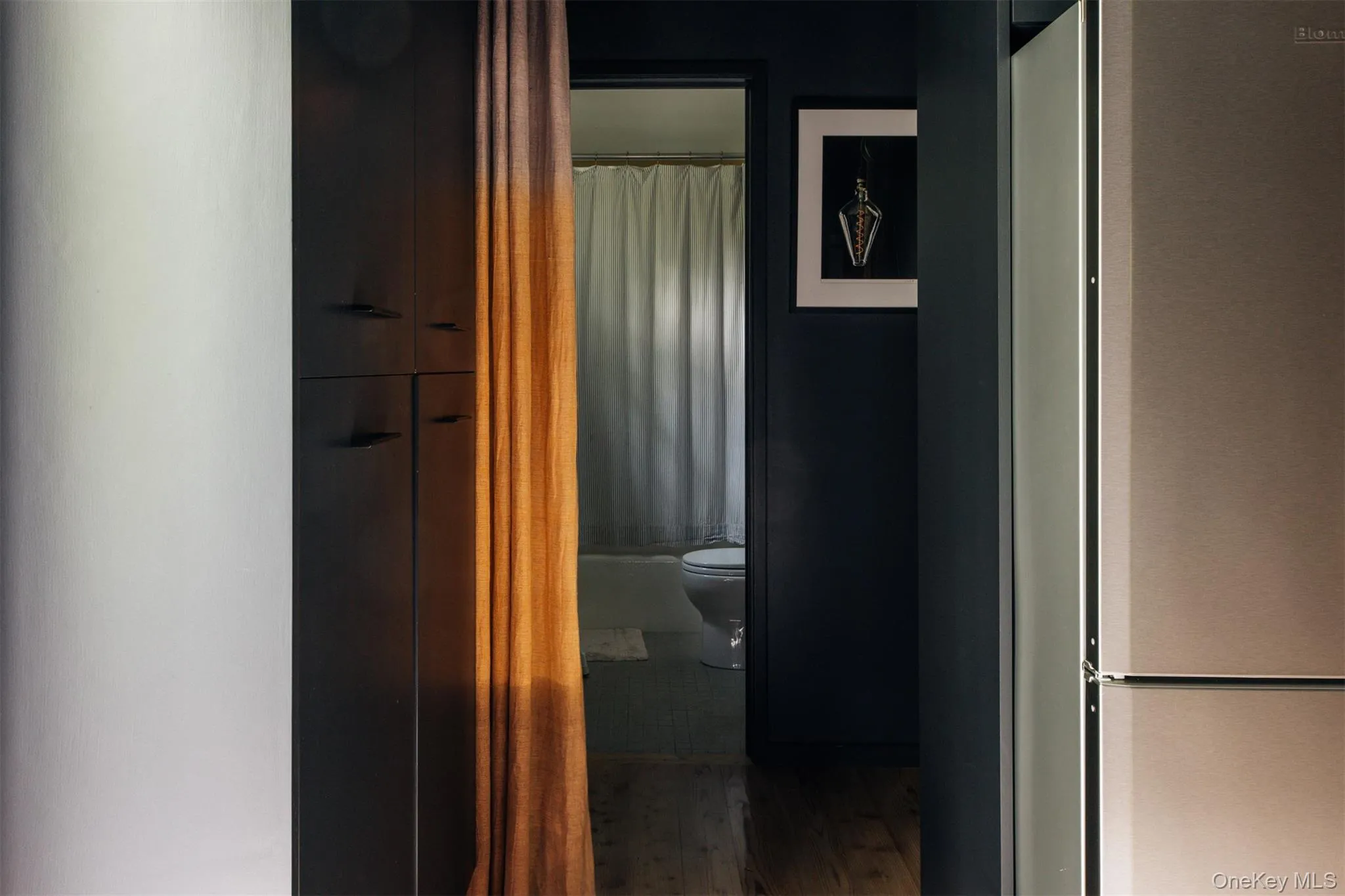 Corridor featuring wood finished floors Corridor featuring wood finished floors