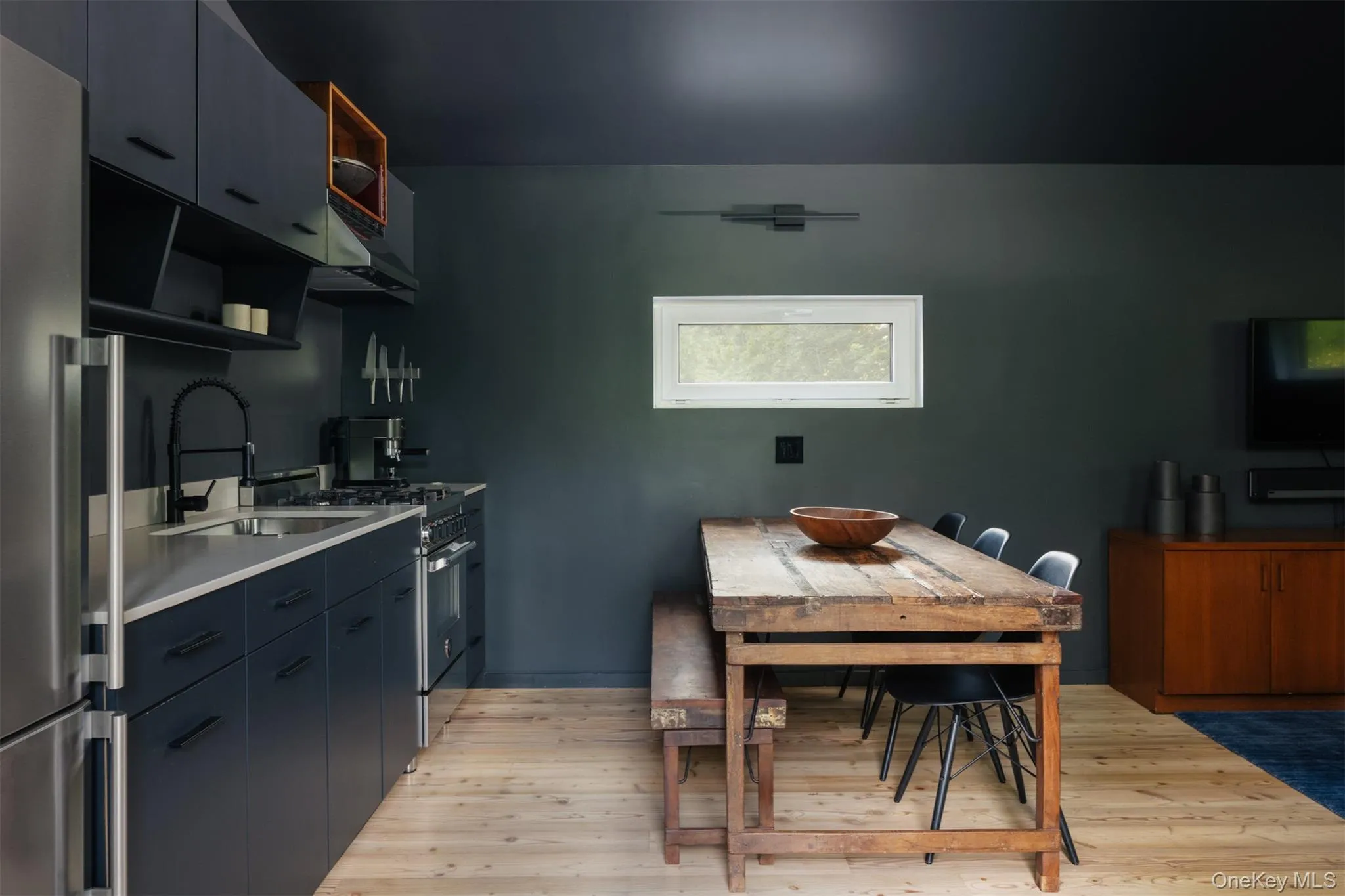 Kitchen featuring open shelves, stainless steel appliances, light wood-style floors, and under cabinet range hood Kitchen featuring open shelves, stainless steel appliances, light wood-style floors, and under cabinet range hood