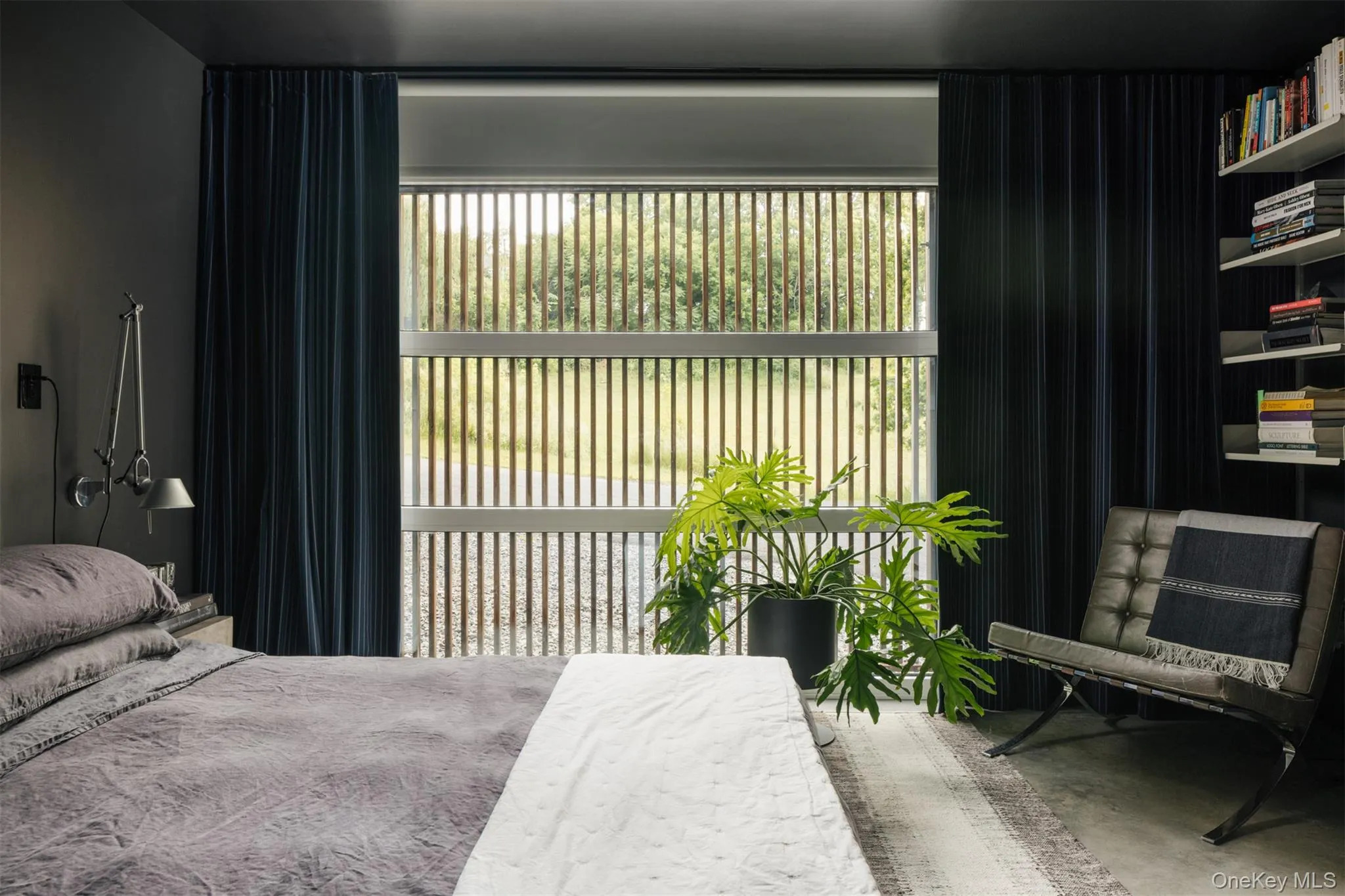 Bedroom featuring concrete flooring and multiple windows Bedroom featuring concrete flooring and multiple windows