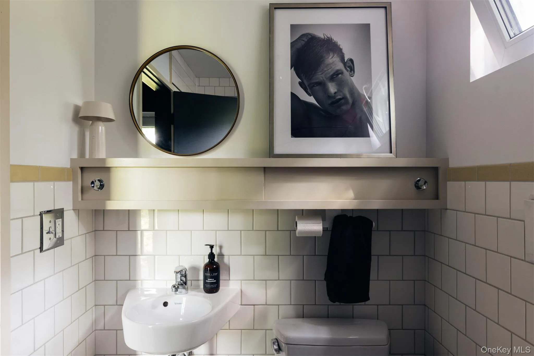 Half bathroom featuring tile walls Half bathroom featuring tile walls