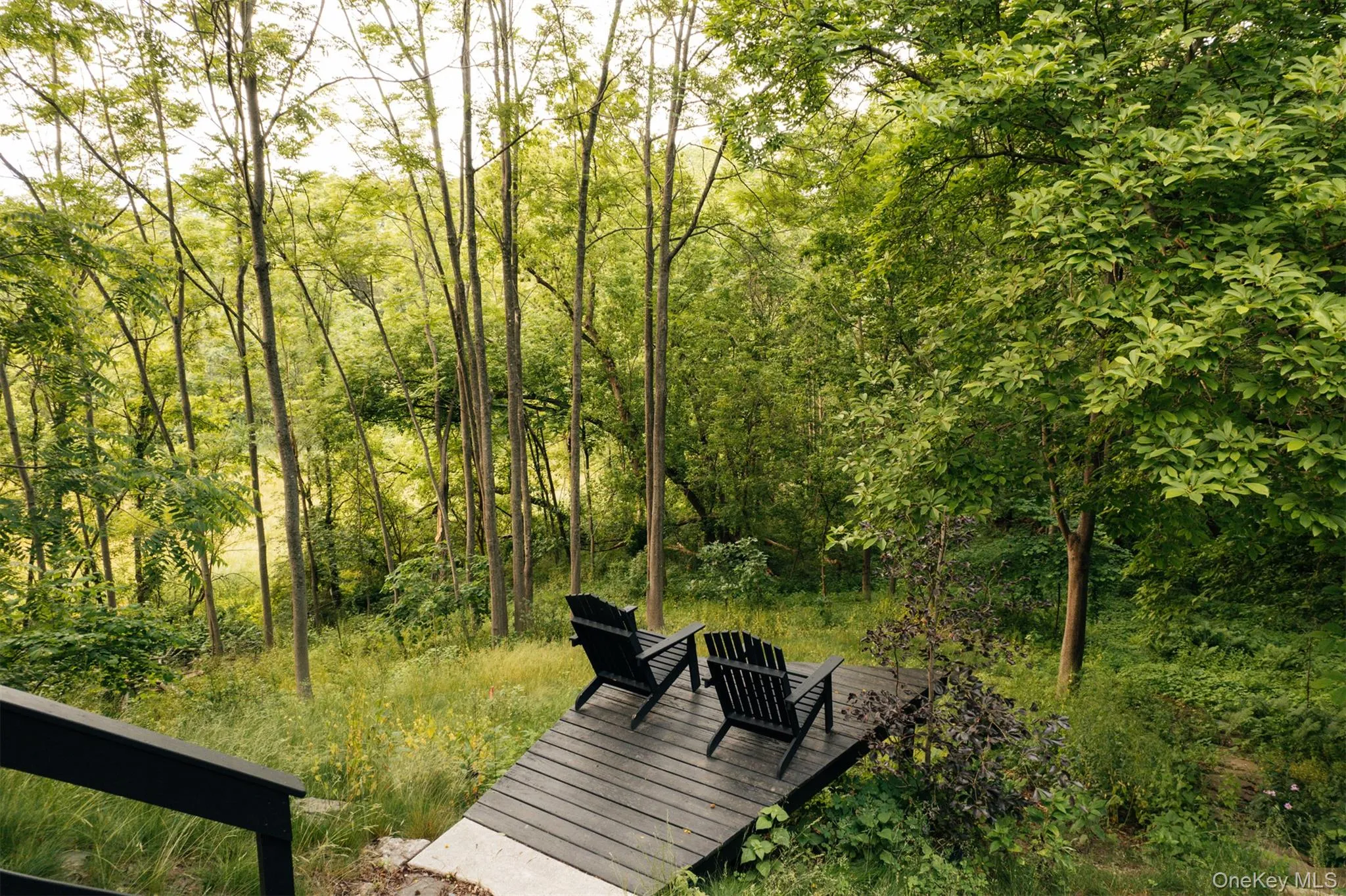 Surrounding community featuring a deck and a forest view Surrounding community featuring a deck and a forest view