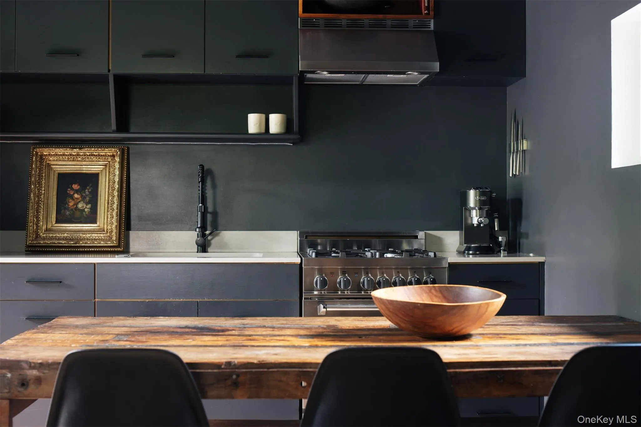 Kitchen with extractor fan, stainless steel gas stove, and gray cabinets Kitchen with extractor fan, stainless steel gas stove, and gray cabinets