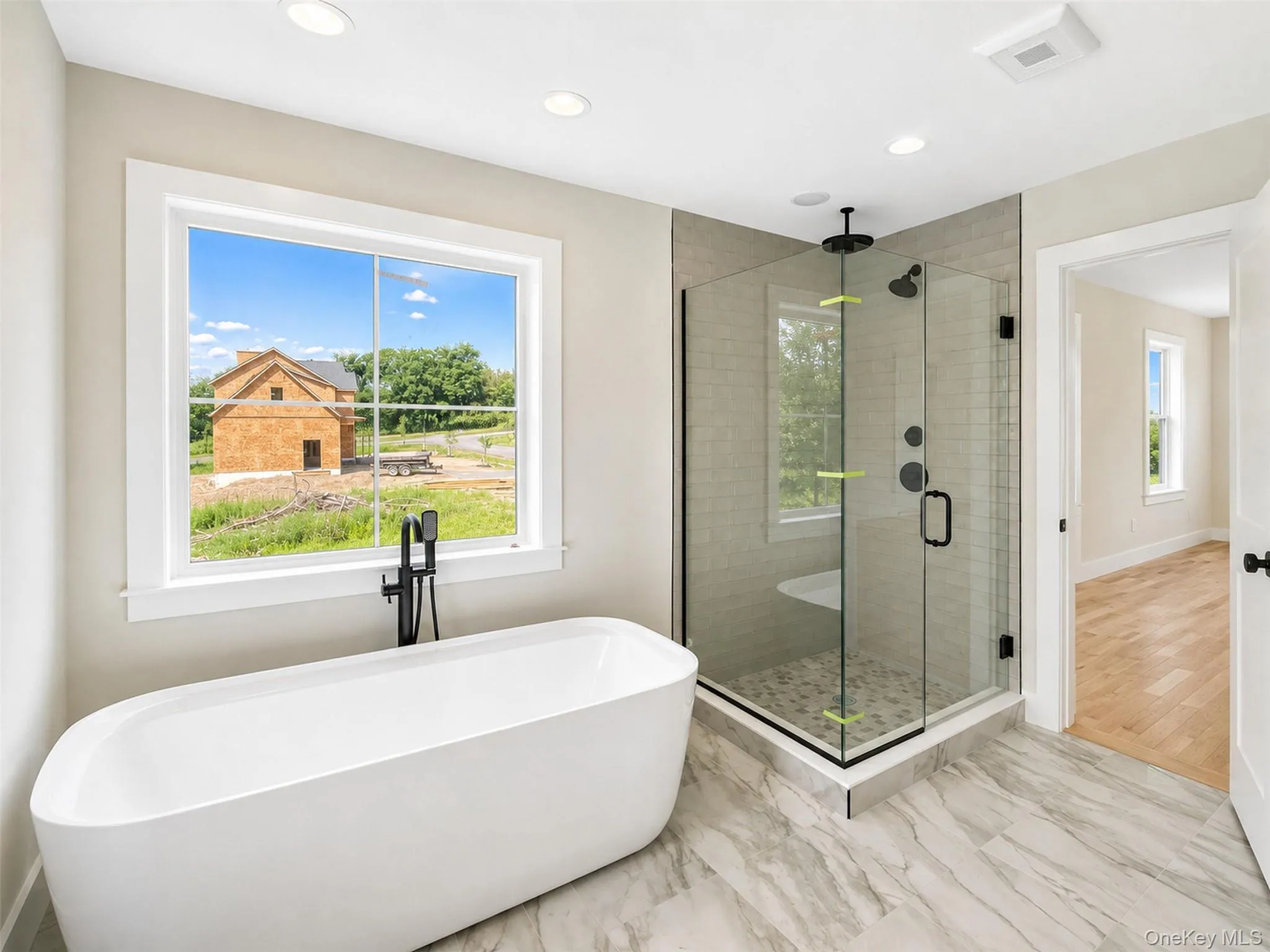 Every detail of the primary bath has been considered, from the elegant tile work, to the oversized glass shower, creating a peaceful everyday escape. Every detail of the primary bath has been considered, from the elegant tile work, to the oversized glass shower, creating a peaceful everyday escape.