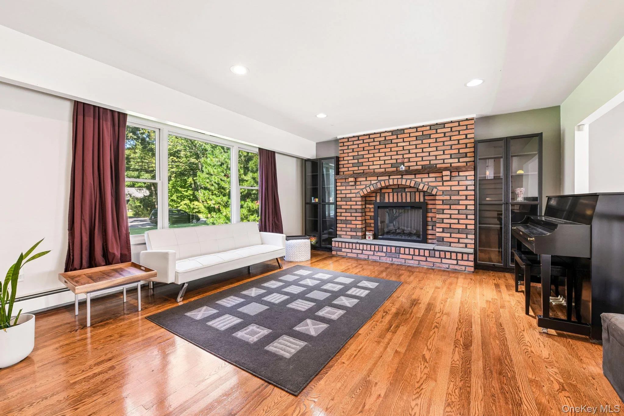 Elevated Living Room with wood floors, high-hats, picture window, wood fireplace, overlooking Den below Elevated Living Room with wood floors, high-hats, picture window, wood fireplace, overlooking Den below