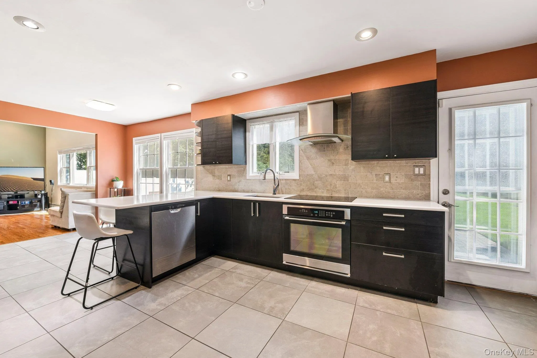 Kitchen with stainless steel appliances, quartz counter top, professional exhaust fan, high hats and exit door to backyard patio. Kitchen with stainless steel appliances, quartz counter top, professional exhaust fan, high hats and exit door to backyard patio.