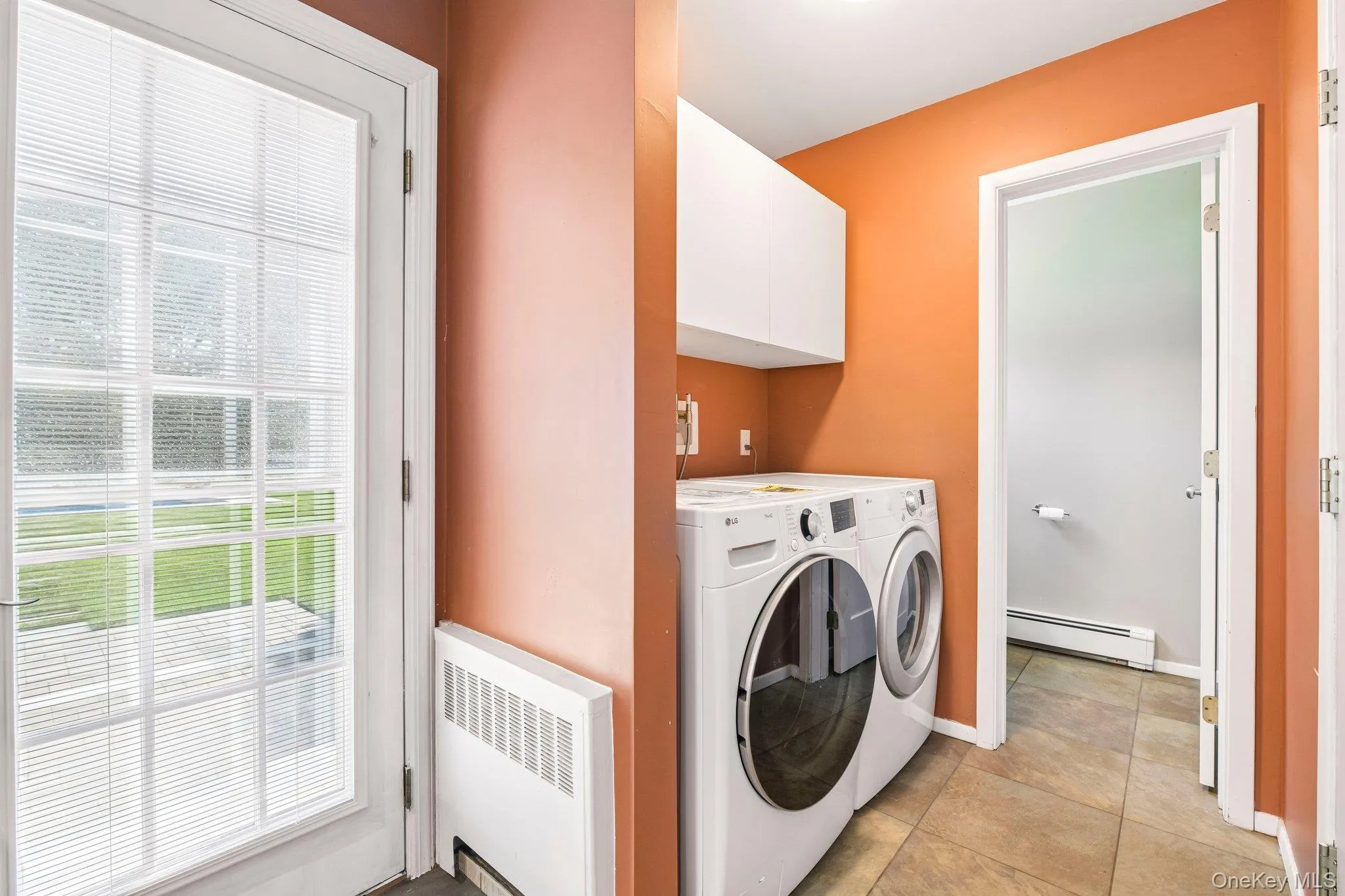 Laundry area with entry to 1/2 bath and exit to attached 1 car garage Laundry area with entry to 1/2 bath and exit to attached 1 car garage