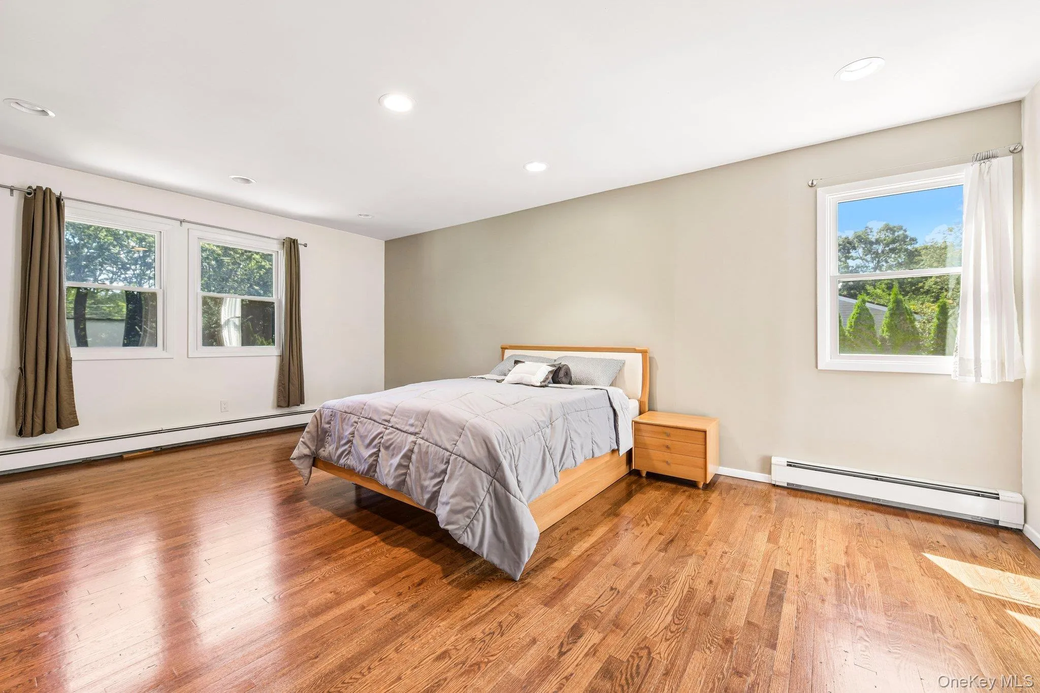 Primary Bedroom suite with back and side view of yard. Primary Bedroom suite with back and side view of yard.