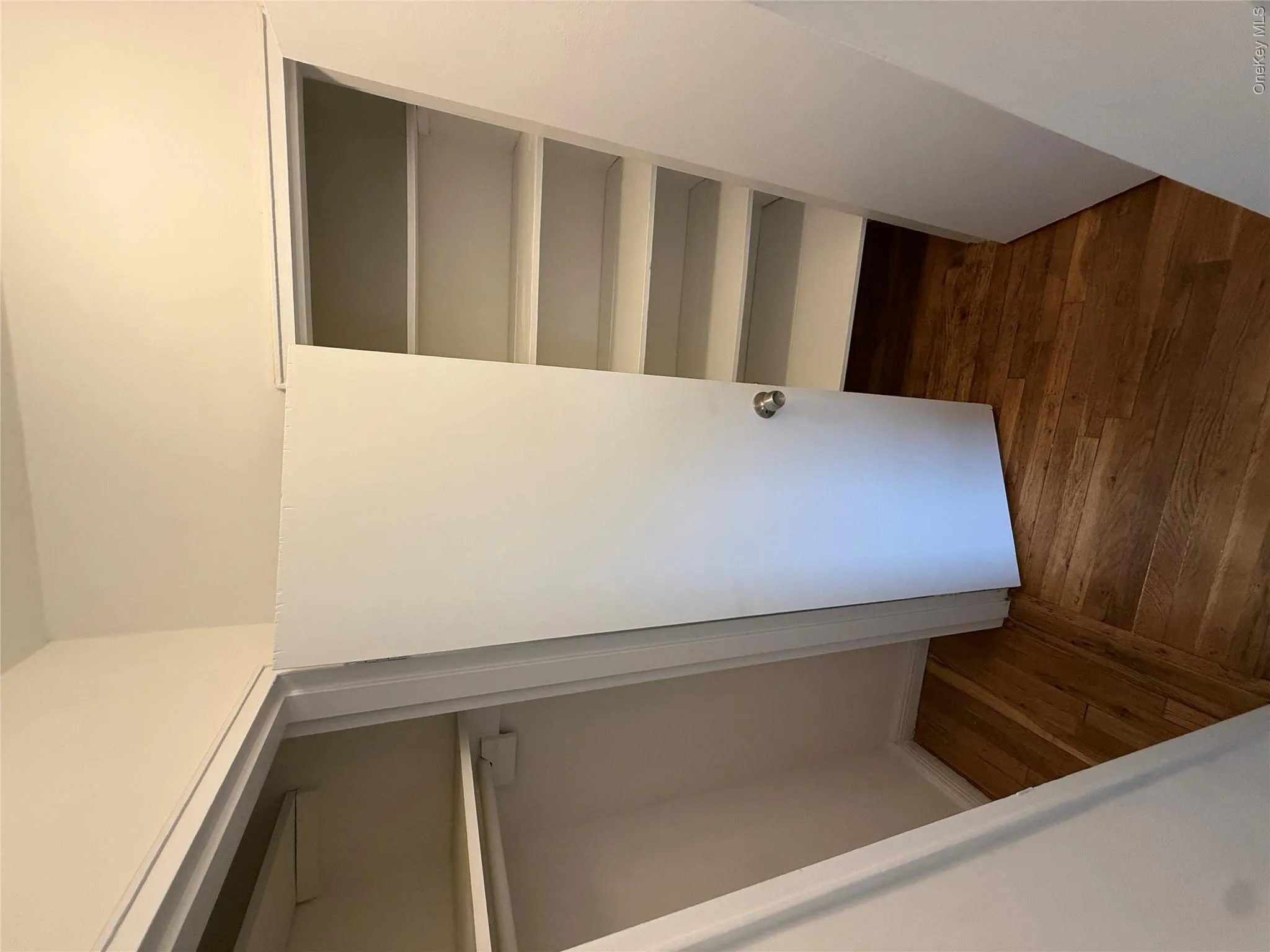 Hardwood-finish flooring, built-in shelving, and white interior doors Hardwood-finish flooring, built-in shelving, and white interior doors