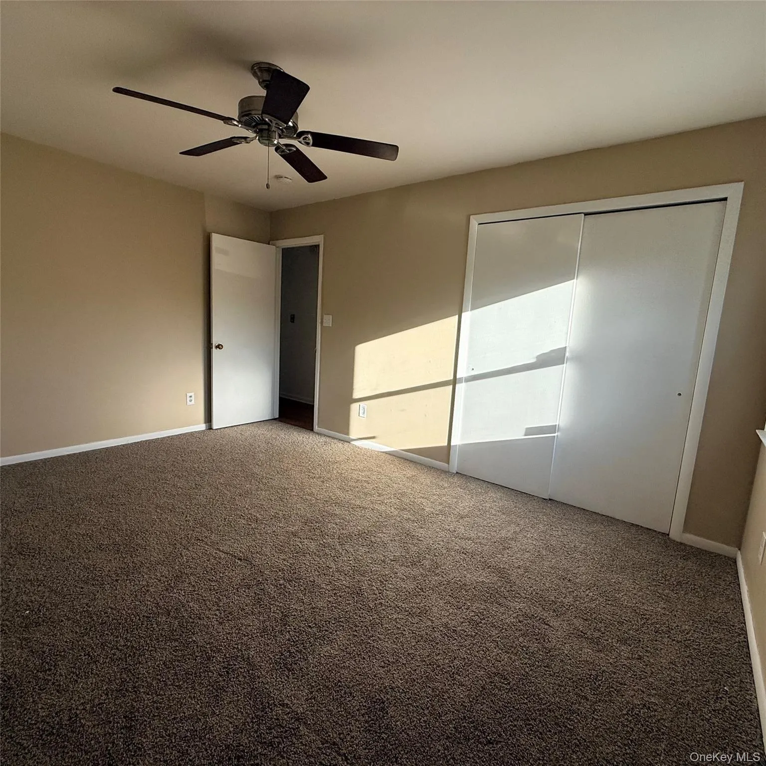 Recessed lighting with a ceiling fan, neutral wall paint, and sliding closet doors Recessed lighting with a ceiling fan, neutral wall paint, and sliding closet doors
