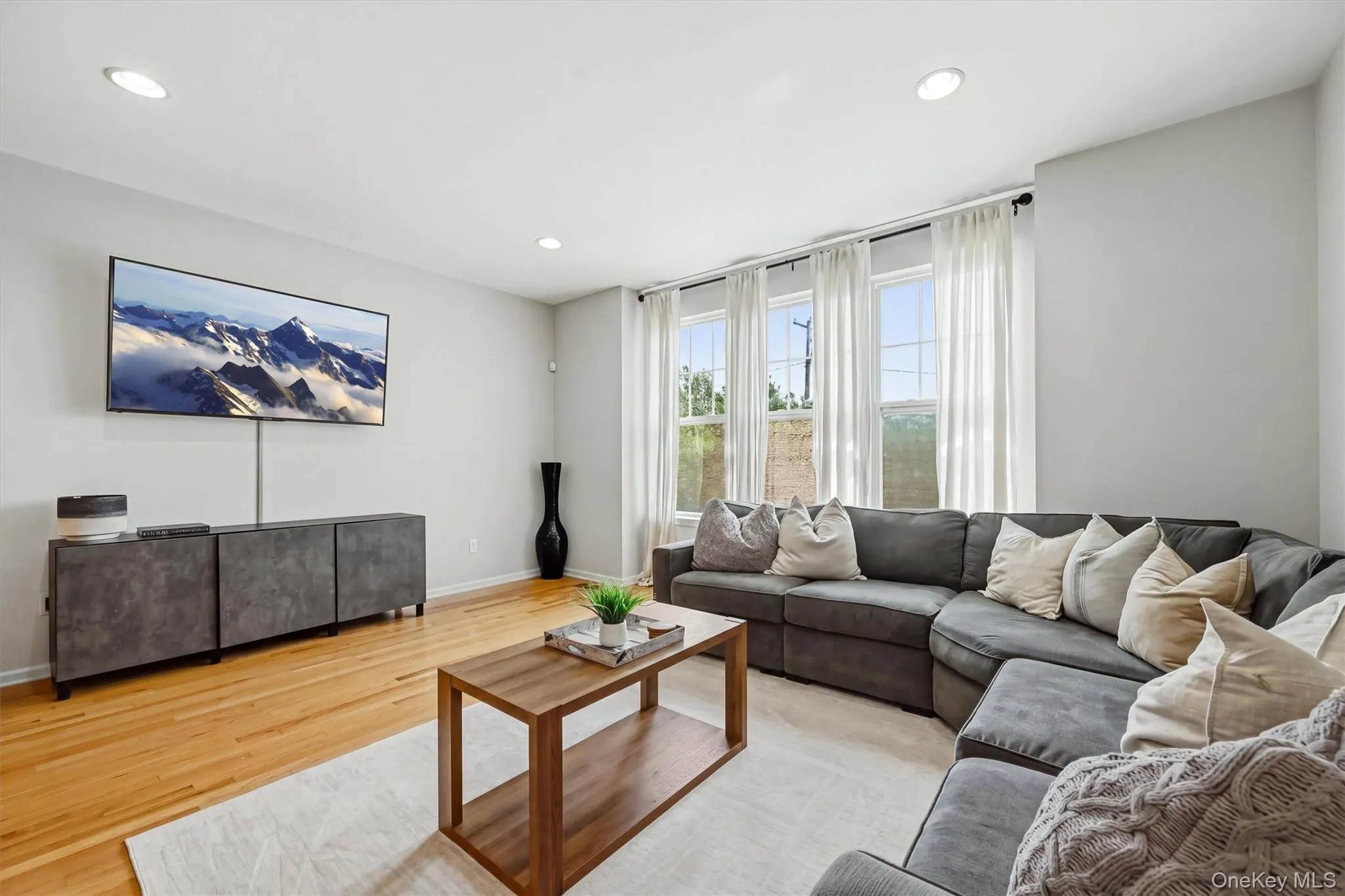 Living Room with large windows and a private view Living Room with large windows and a private view