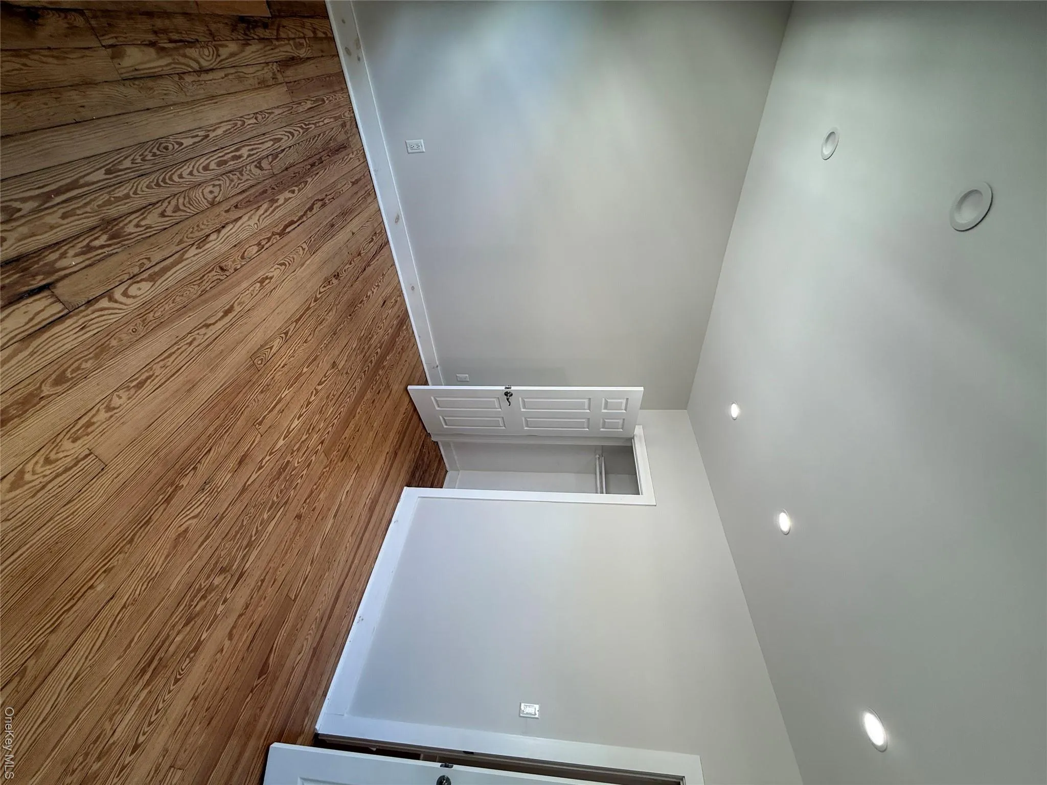 Recessed ceiling lighting, wood-finish flooring, light neutral wall tones, and white trim Recessed ceiling lighting, wood-finish flooring, light neutral wall tones, and white trim