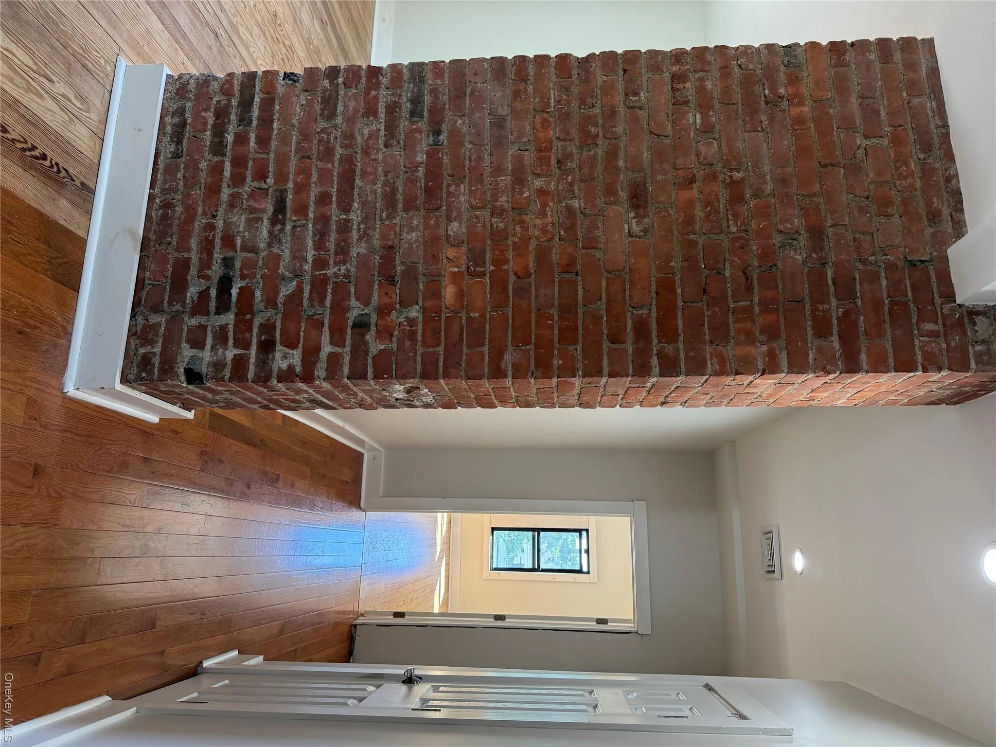 Exposed brick column accenting wood-finish flooring Exposed brick column accenting wood-finish flooring