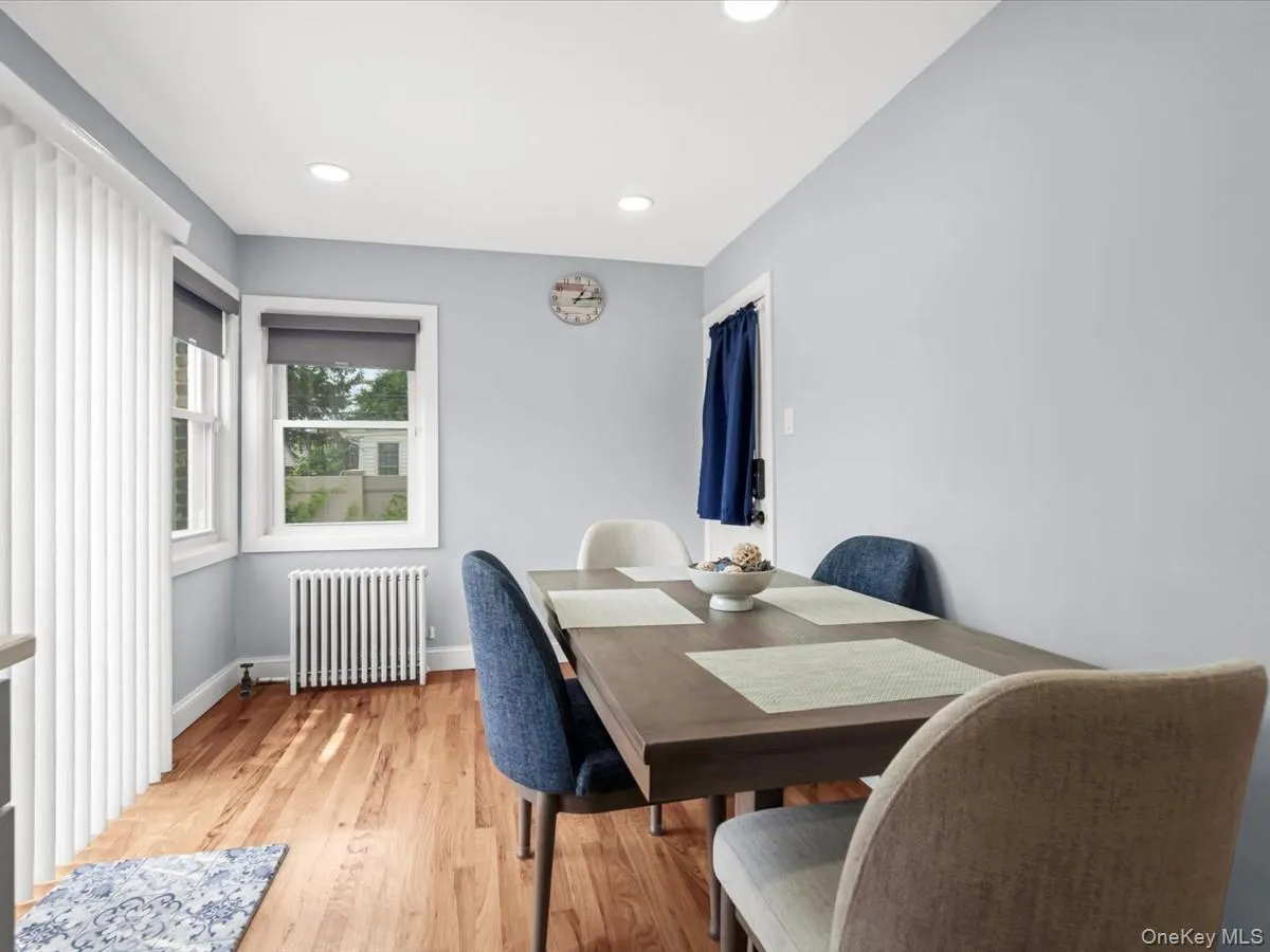 Wood-finish flooring with light blue walls and recessed ceiling lighting Wood-finish flooring with light blue walls and recessed ceiling lighting