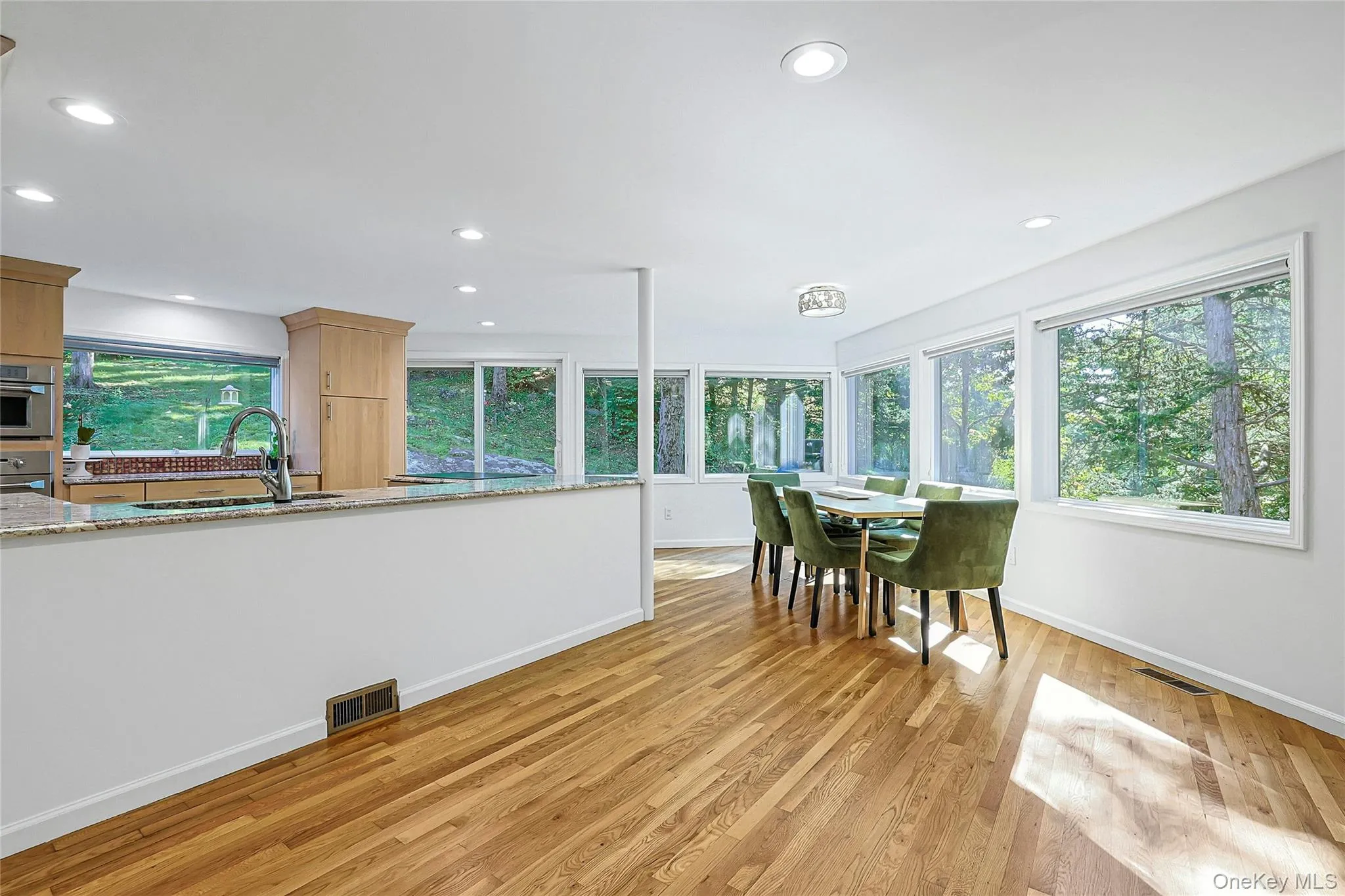 Light-filled dining room surrounded by windows, bringing in abundant natural light and creating a bright, inviting setting for everyday meals and entertaining. Light-filled dining room surrounded by windows, bringing in abundant natural light and creating a bright, inviting setting for everyday meals and entertaining.