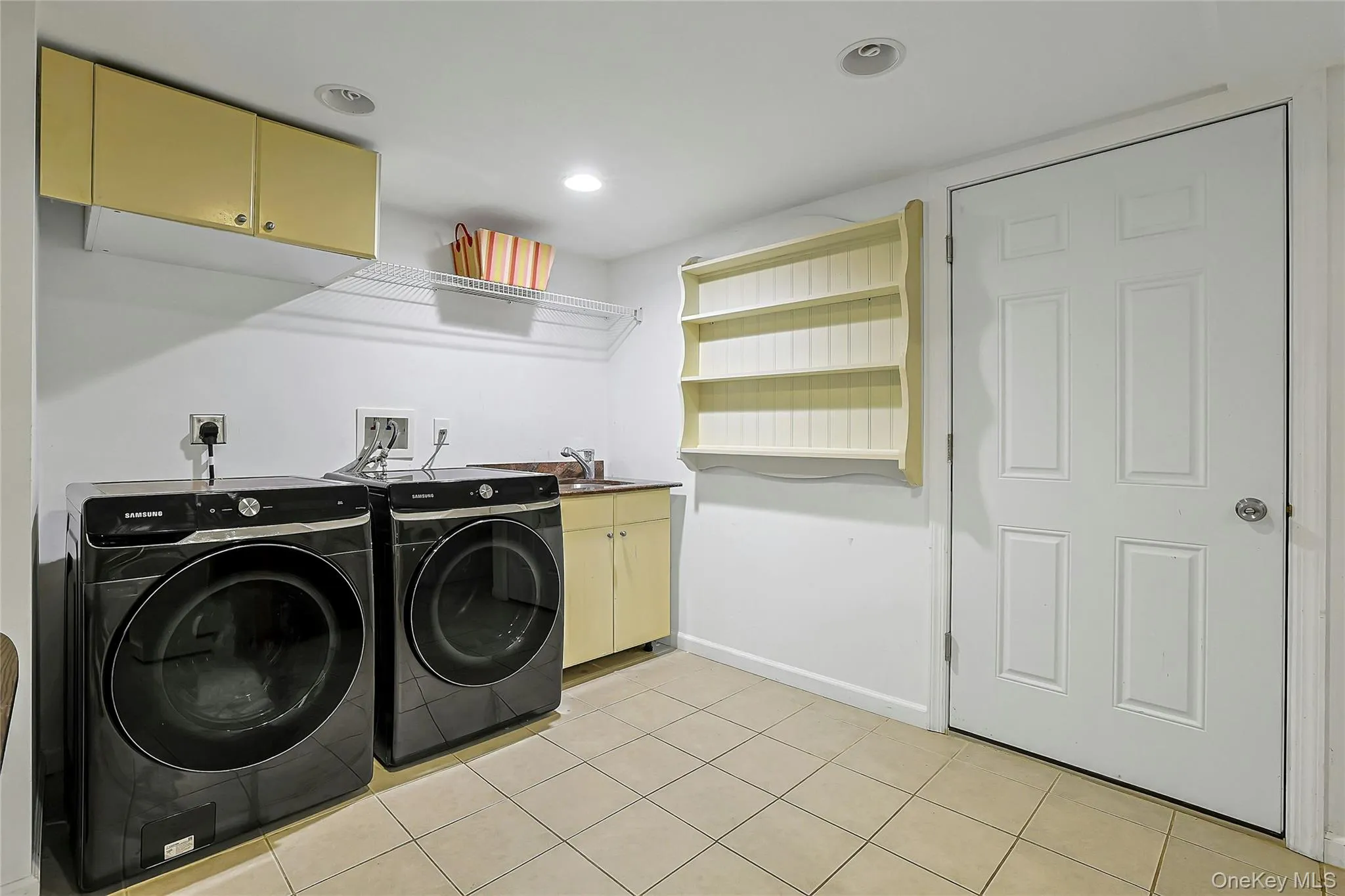 Convenient laundry room with washer and dryer adds ease and functionality to the home. Convenient laundry room with washer and dryer adds ease and functionality to the home.