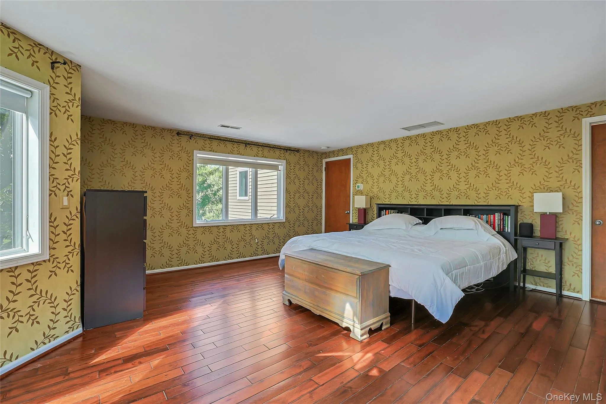 Large primary bedroom offers a welcoming retreat with plenty of space for a sitting area, additional furnishings, and a comfortable place to unwind at the end of the day. Large primary bedroom offers a welcoming retreat with plenty of space for a sitting area, additional furnishings, and a comfortable place to unwind at the end of the day.