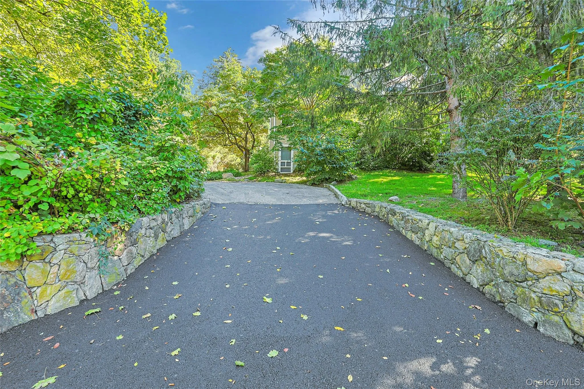Long driveway offers ample parking and a welcoming approach to the home. Long driveway offers ample parking and a welcoming approach to the home.