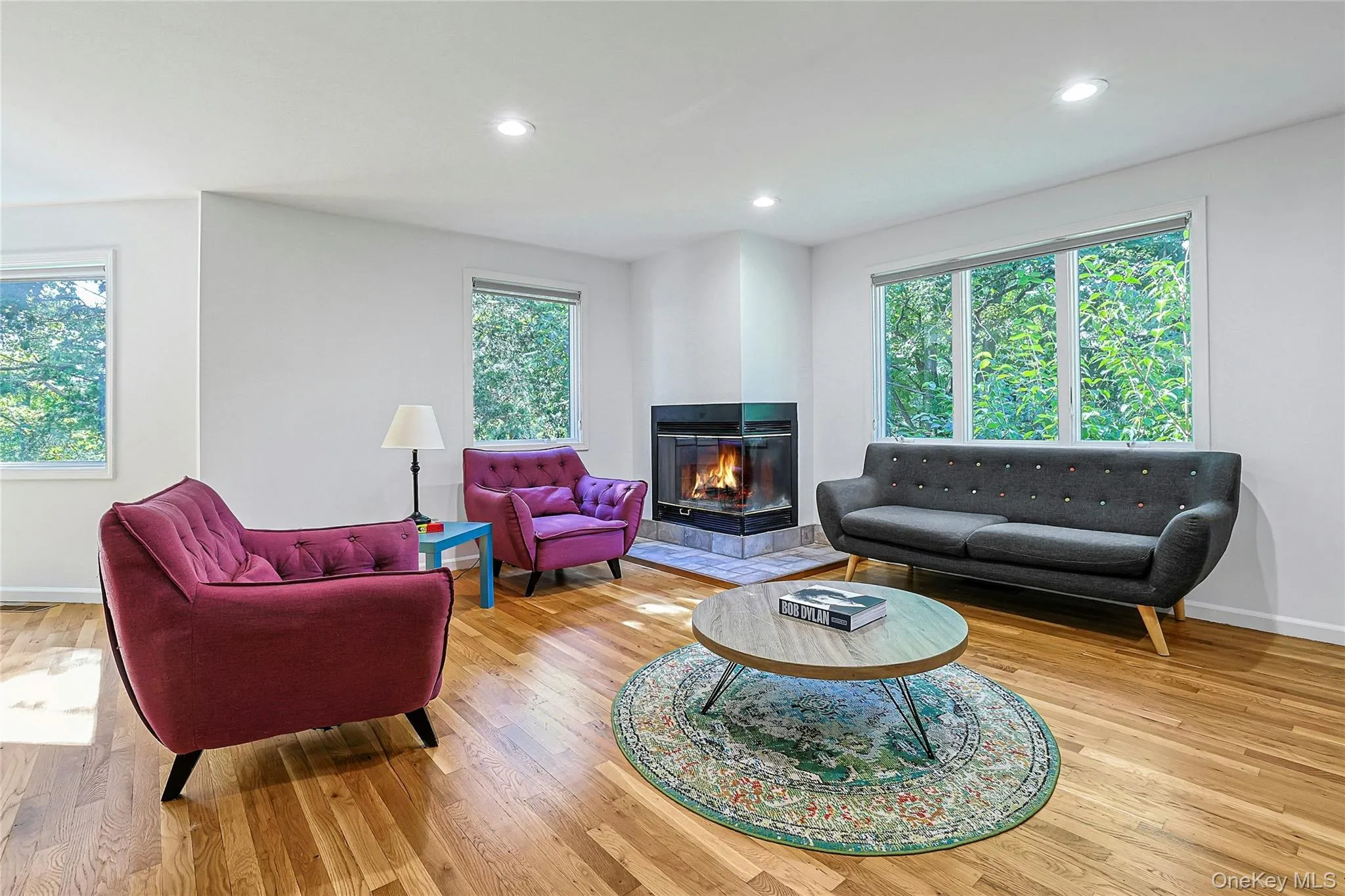 A striking fireplace serves as the focal point of the living room, adding warmth and character A striking fireplace serves as the focal point of the living room, adding warmth and character