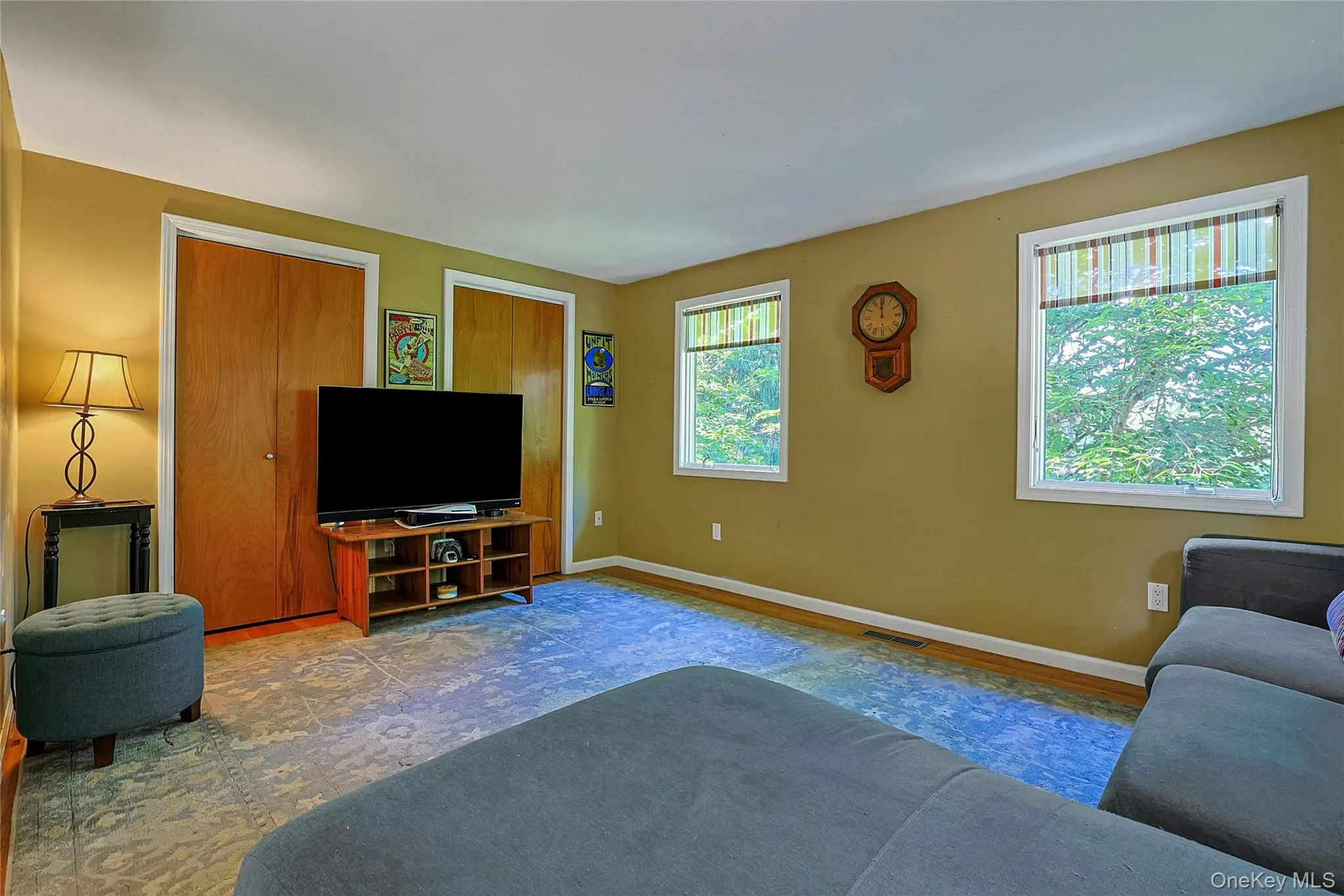 Family room features two large windows that fill the space with natural light and offer views of the surrounding setting. Family room features two large windows that fill the space with natural light and offer views of the surrounding setting.