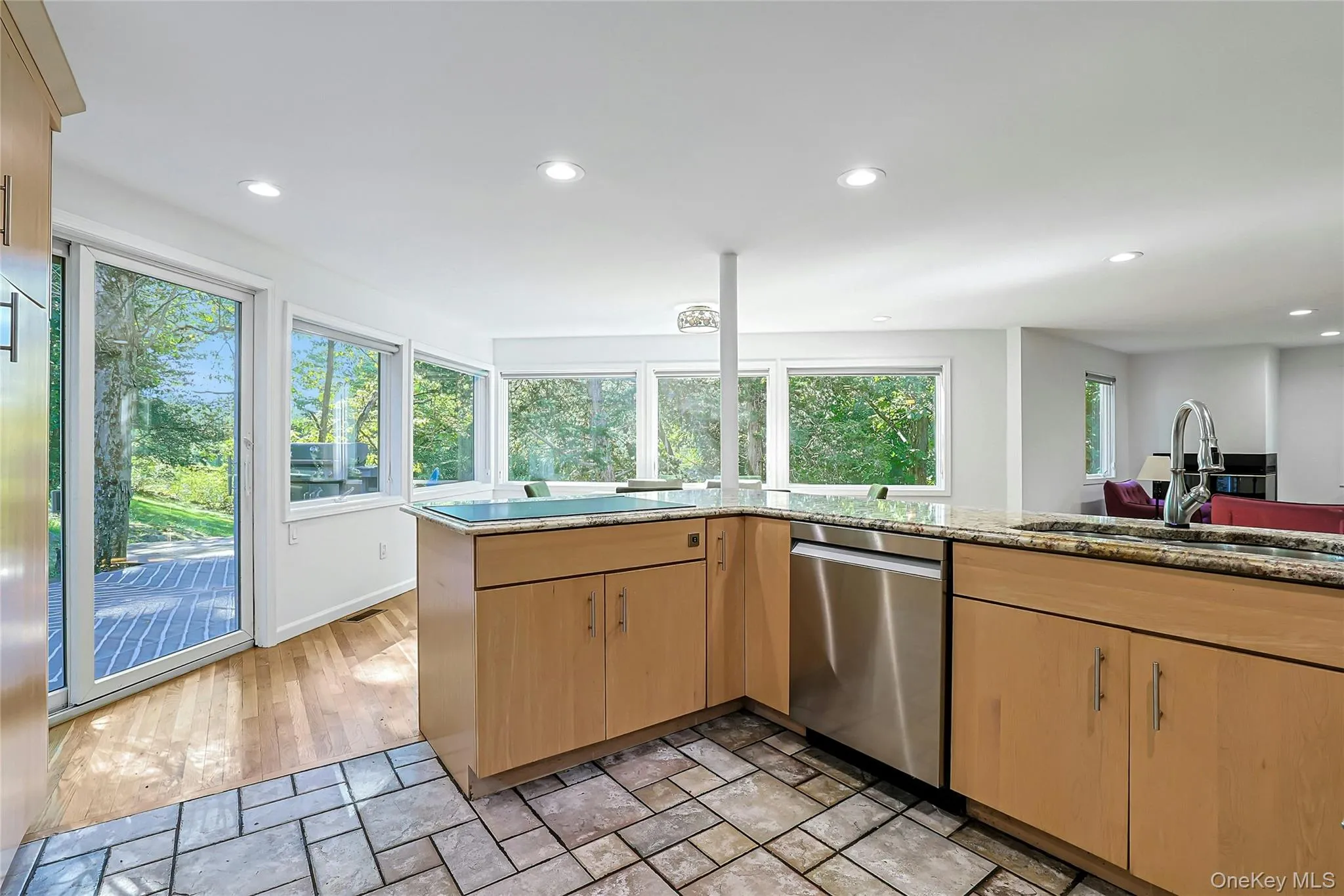 Sliding glass door just off the kitchen provides easy access outdoors and brings even more natural light into the space. Sliding glass door just off the kitchen provides easy access outdoors and brings even more natural light into the space.