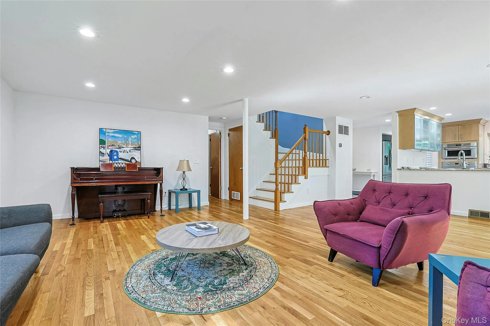 Spacious living room with staircase access to the upper level, creating a natural connection between the home’s main living areas and bedrooms above. Spacious living room with staircase access to the upper level, creating a natural connection between the home’s main living areas and bedrooms above.