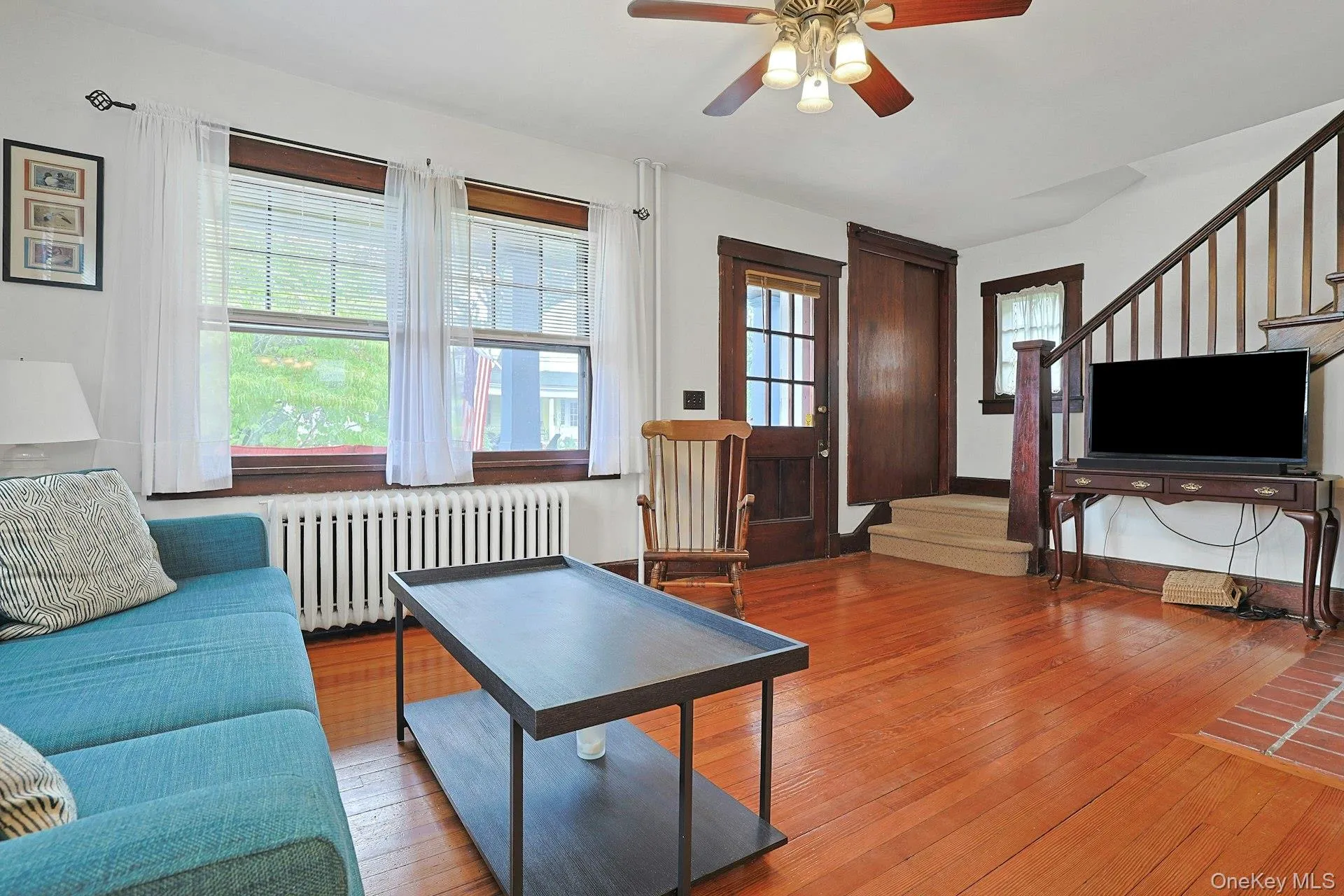 An abundance of windows fills the living room with warm natural light. An abundance of windows fills the living room with warm natural light.