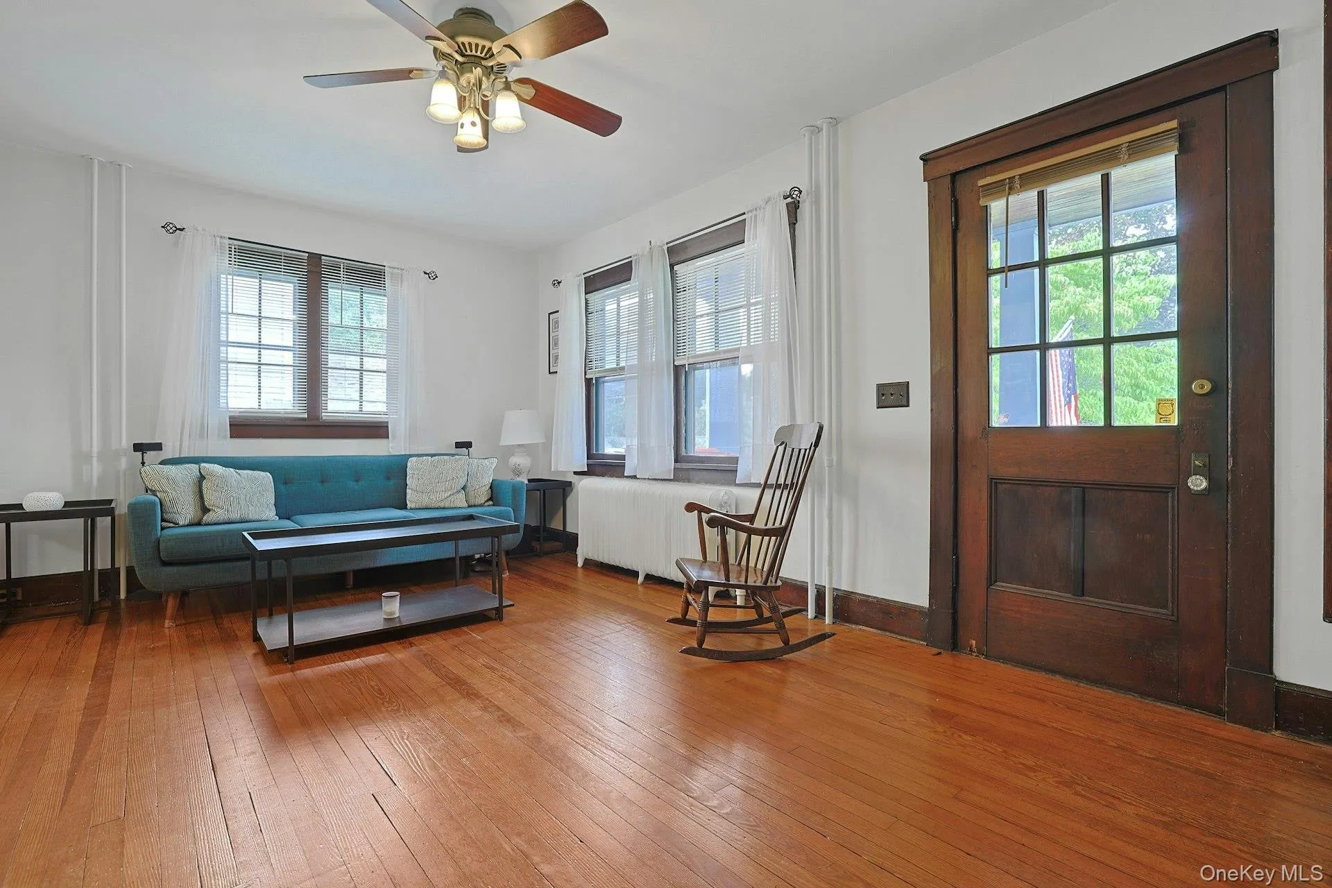 The comfortable, light-filled living room has walls of windows. The comfortable, light-filled living room has walls of windows.