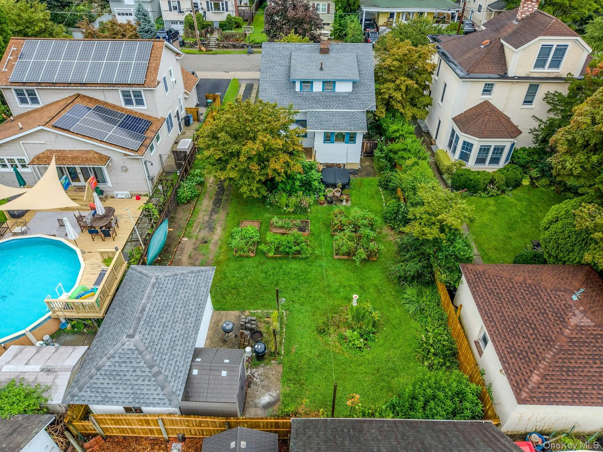 A beautiful aerial view showcasing the spacious backyard, garden areas, and the wonderful outdoor setting. A beautiful aerial view showcasing the spacious backyard, garden areas, and the wonderful outdoor setting.