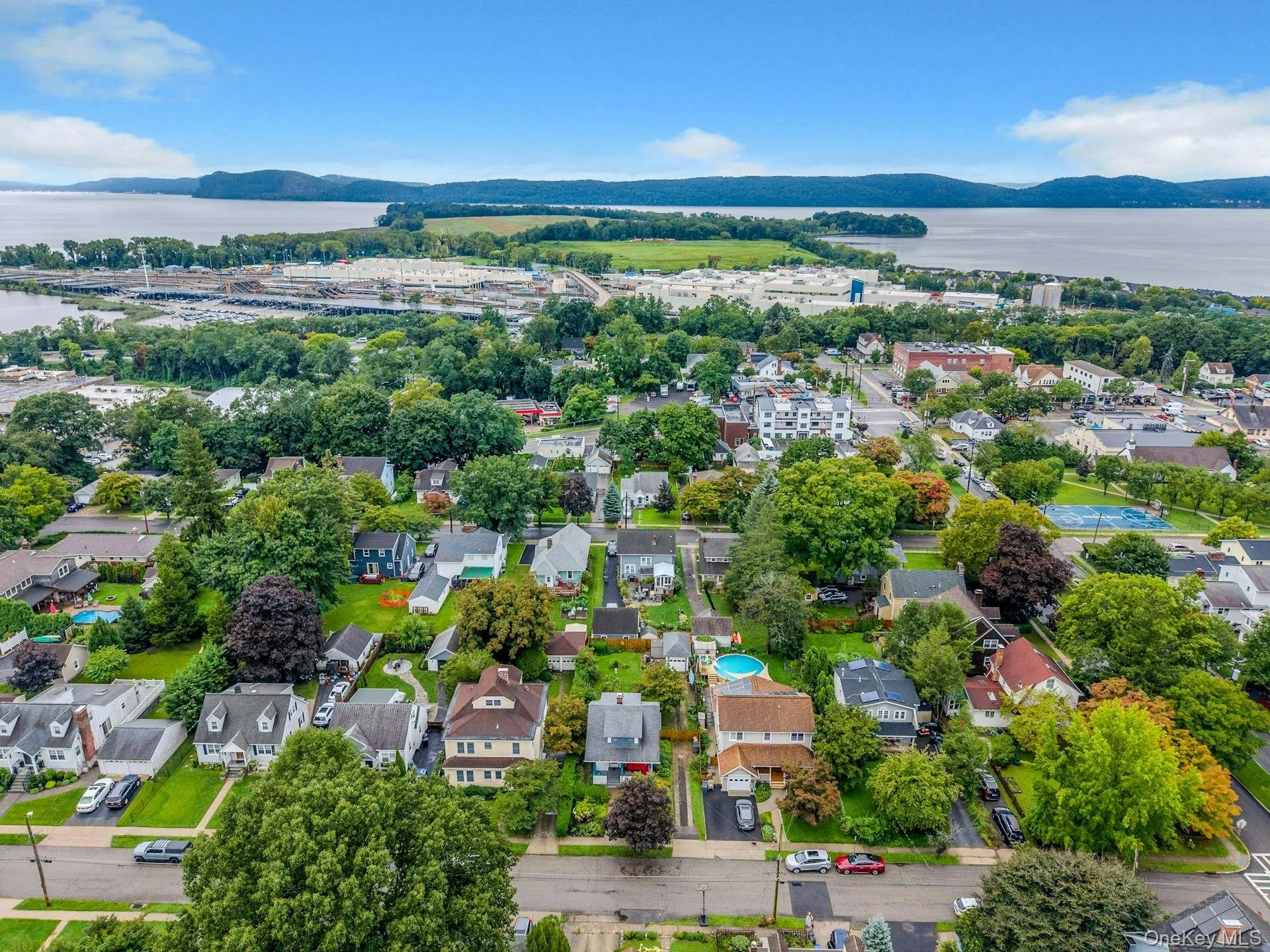 This aerial view highlights the home’s convenient proximity to the Metro-North station, making commuting to New York City easy and accessible. This aerial view highlights the home’s convenient proximity to the Metro-North station, making commuting to New York City easy and accessible.